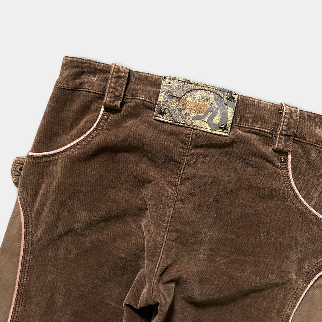 A pair of brown jeans with a label on the waistband.