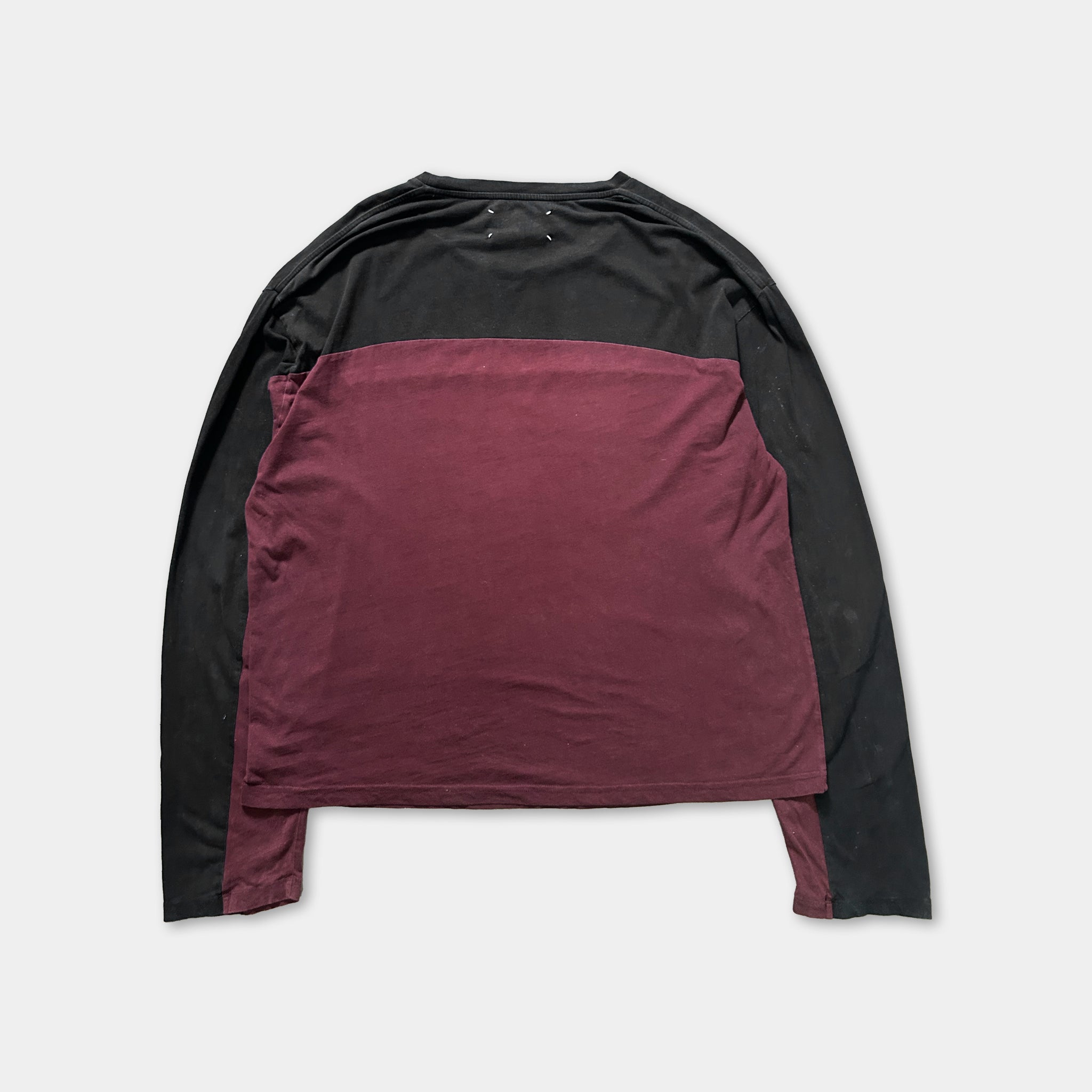 a long-sleeved shirt with a maroon and black color scheme.