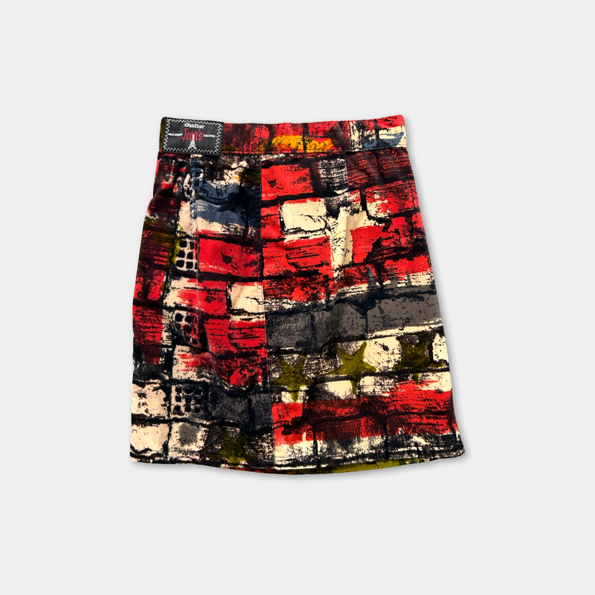 a colorful, abstract skirt with a bold, geometric pattern in red, black, and white.