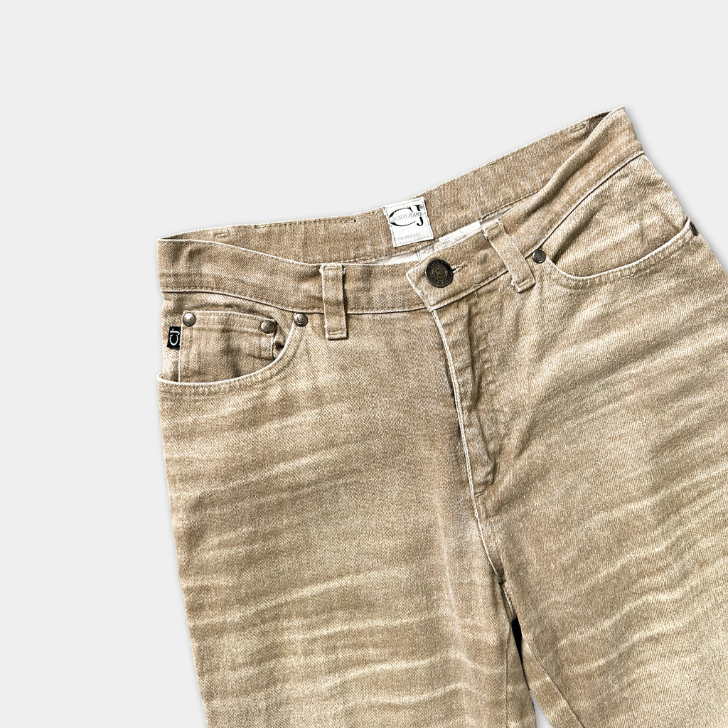 A pair of tan-colored jeans with a label on the waistband.