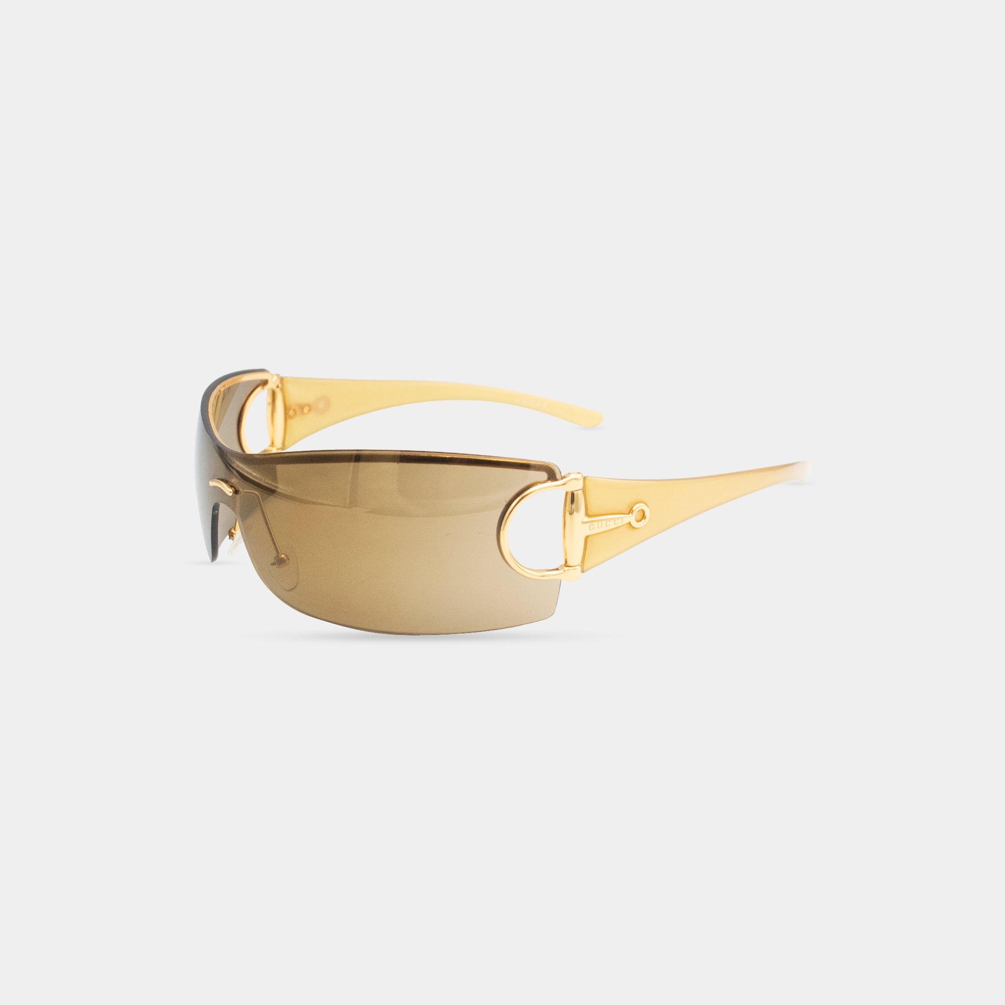 A pair of gold-colored sunglasses with a brown frame.