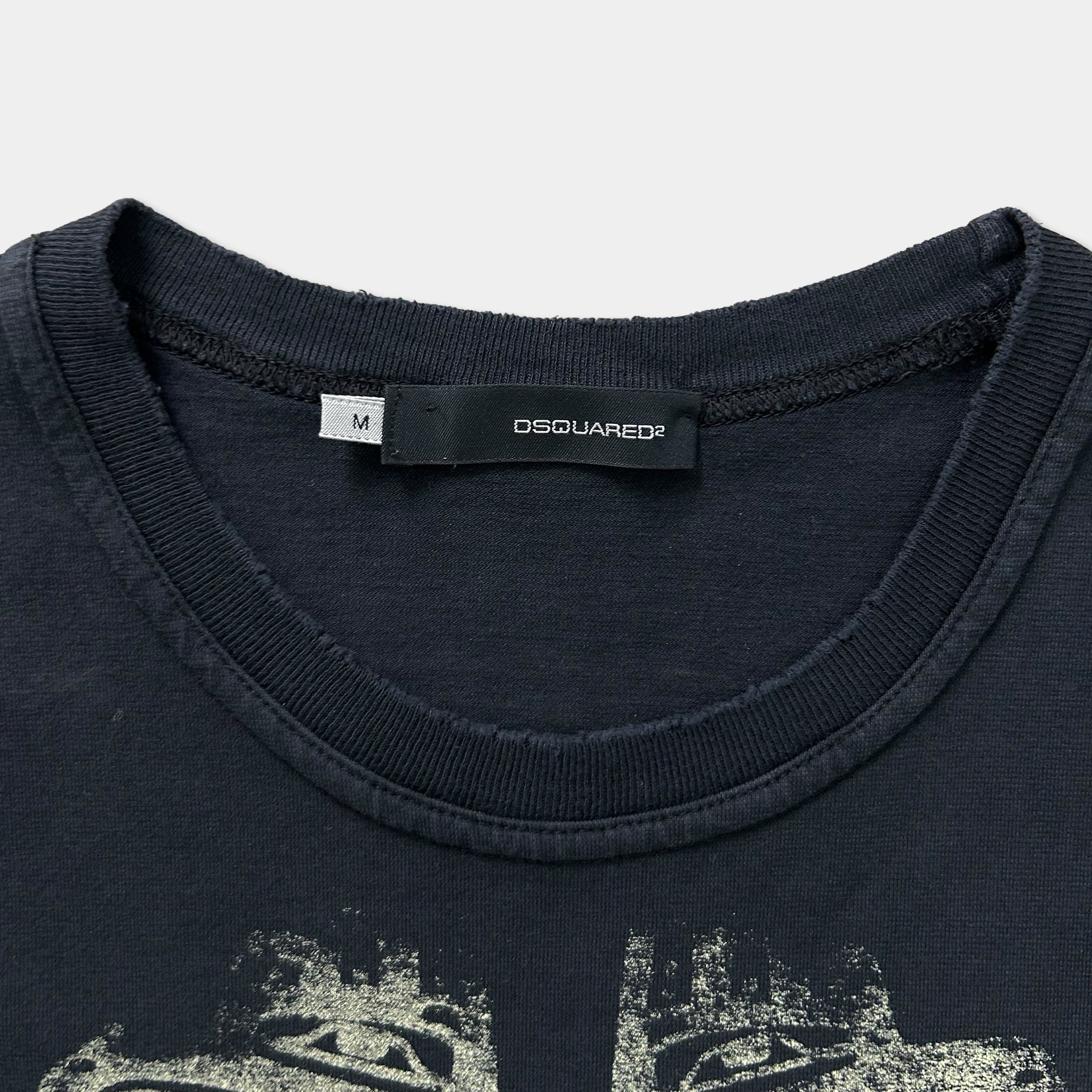a close-up view of a dark-colored t-shirt with a label on the collar.