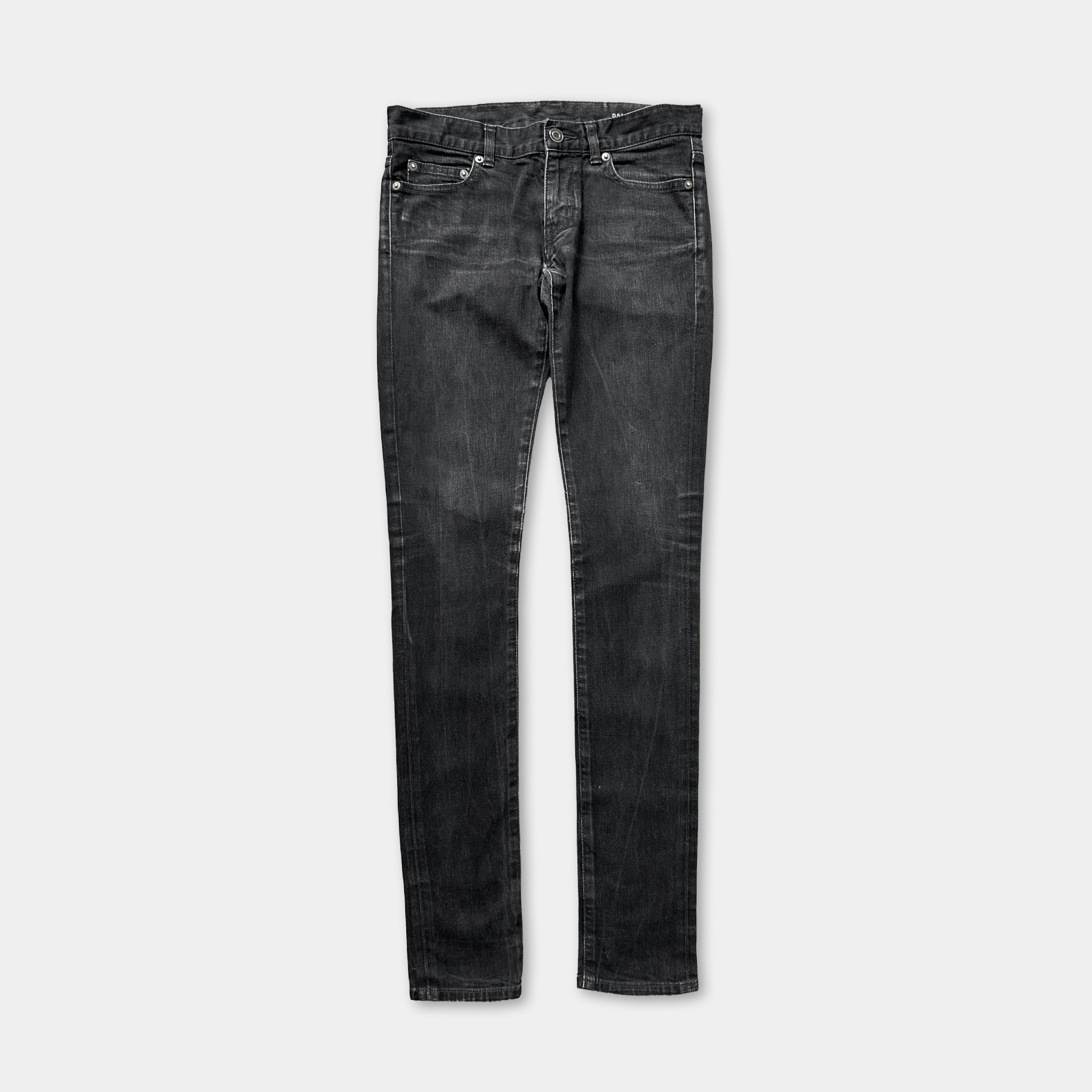 A pair of black skinny jeans against a white background.