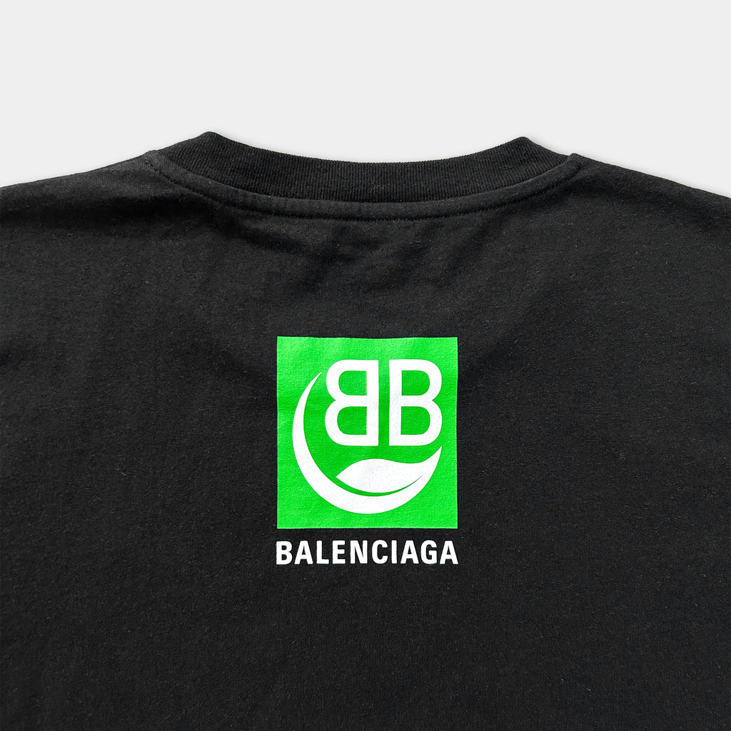 a black t-shirt with a green square logo and text on the back.