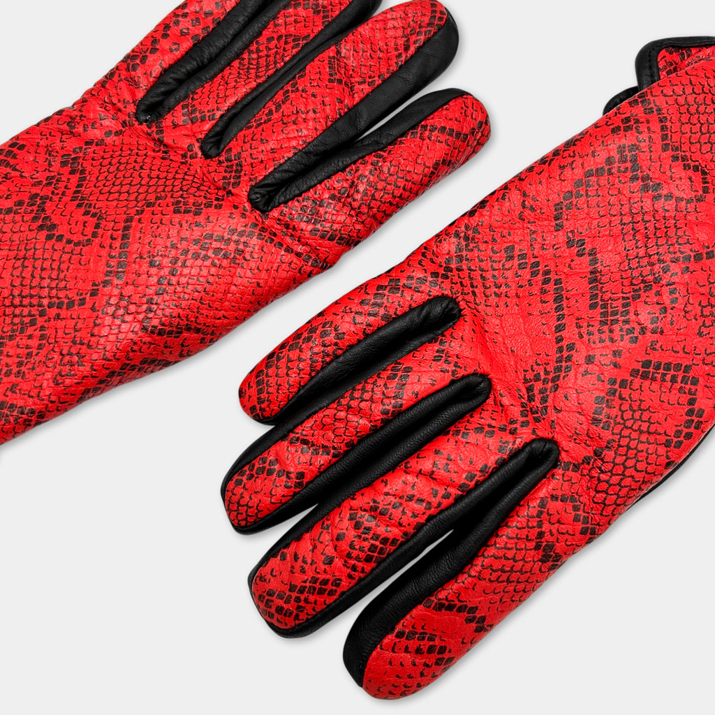 A pair of red and black patterned gloves with a distinctive snake skin texture.