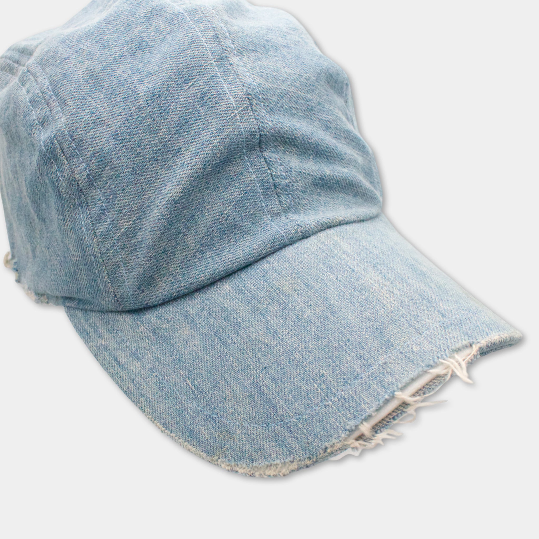A worn and frayed blue denim baseball cap.