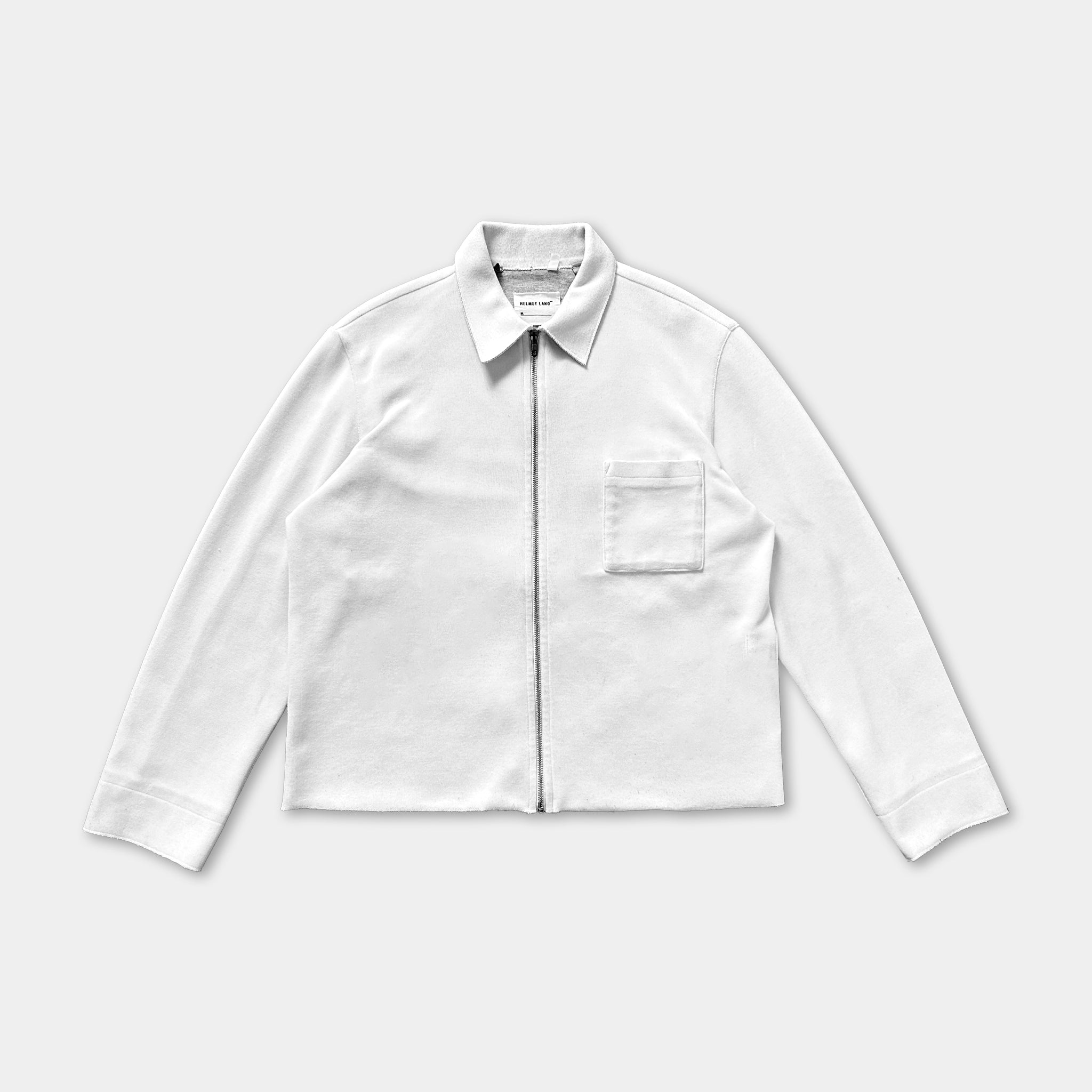 A white long-sleeved shirt with a zipper and a small pocket on the front.
