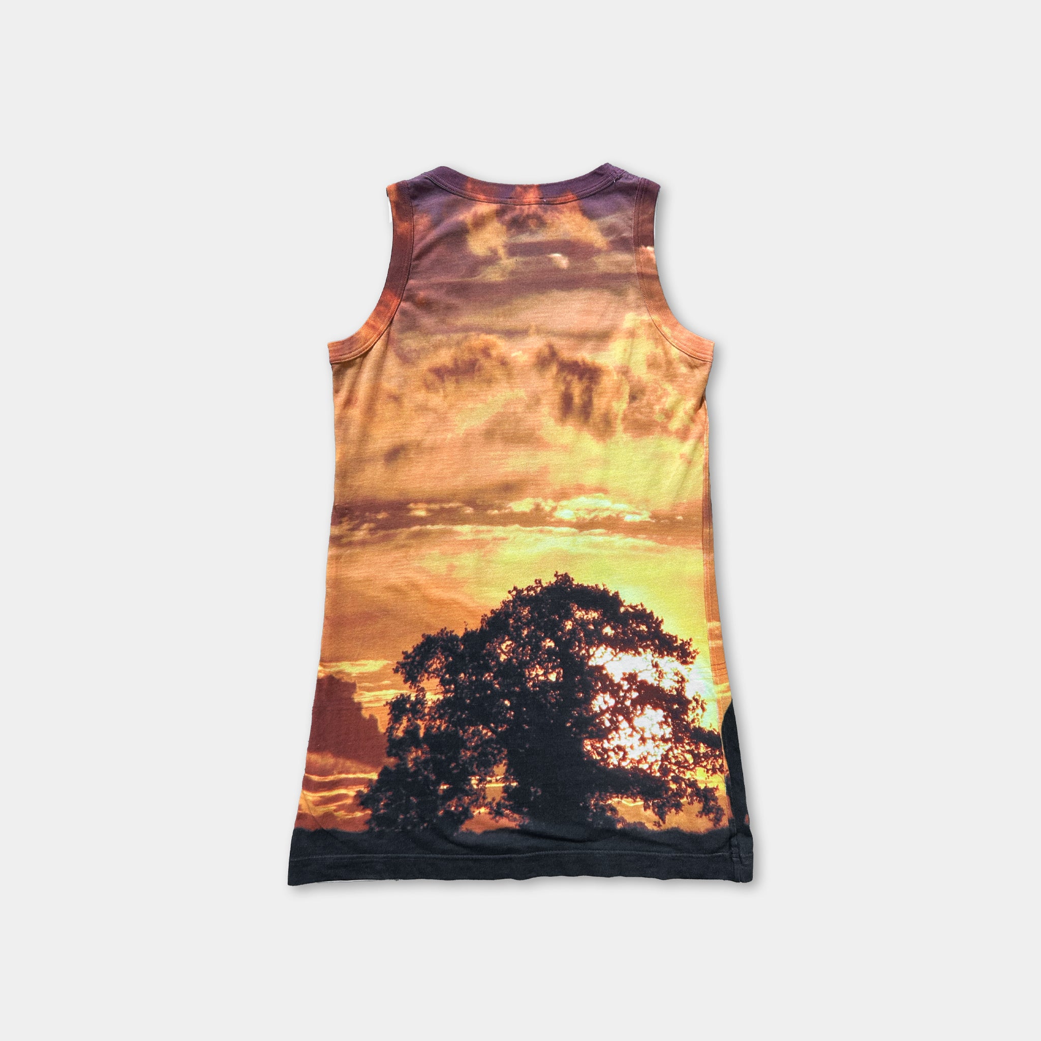 The image is a tank top with a printed design depicting a sunset over a tree.
