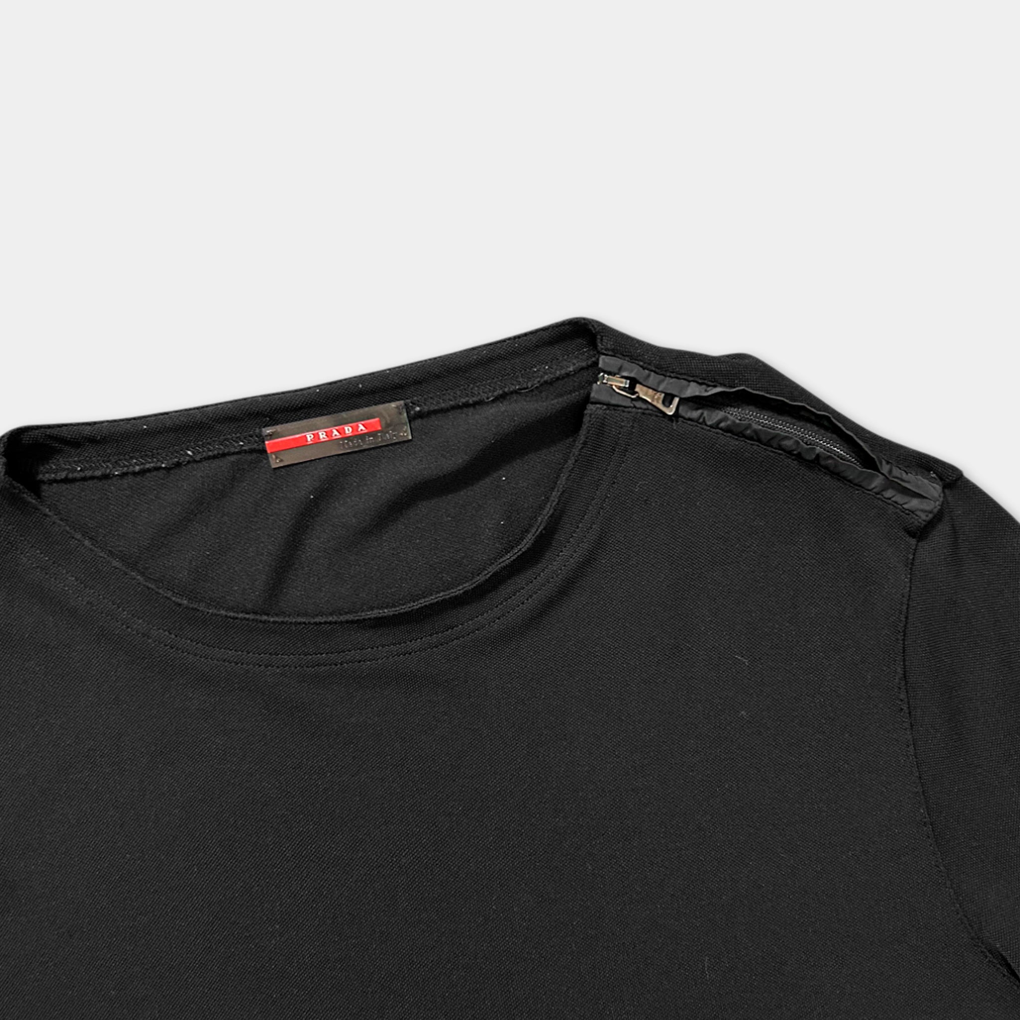 A black t-shirt with a red label on the collar.