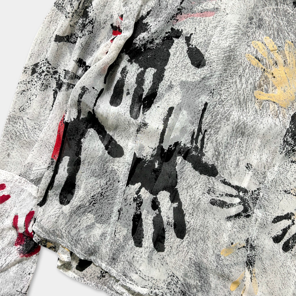 a close-up view of a fabric with a black and white abstract design, including splatters and splotches of various colors.