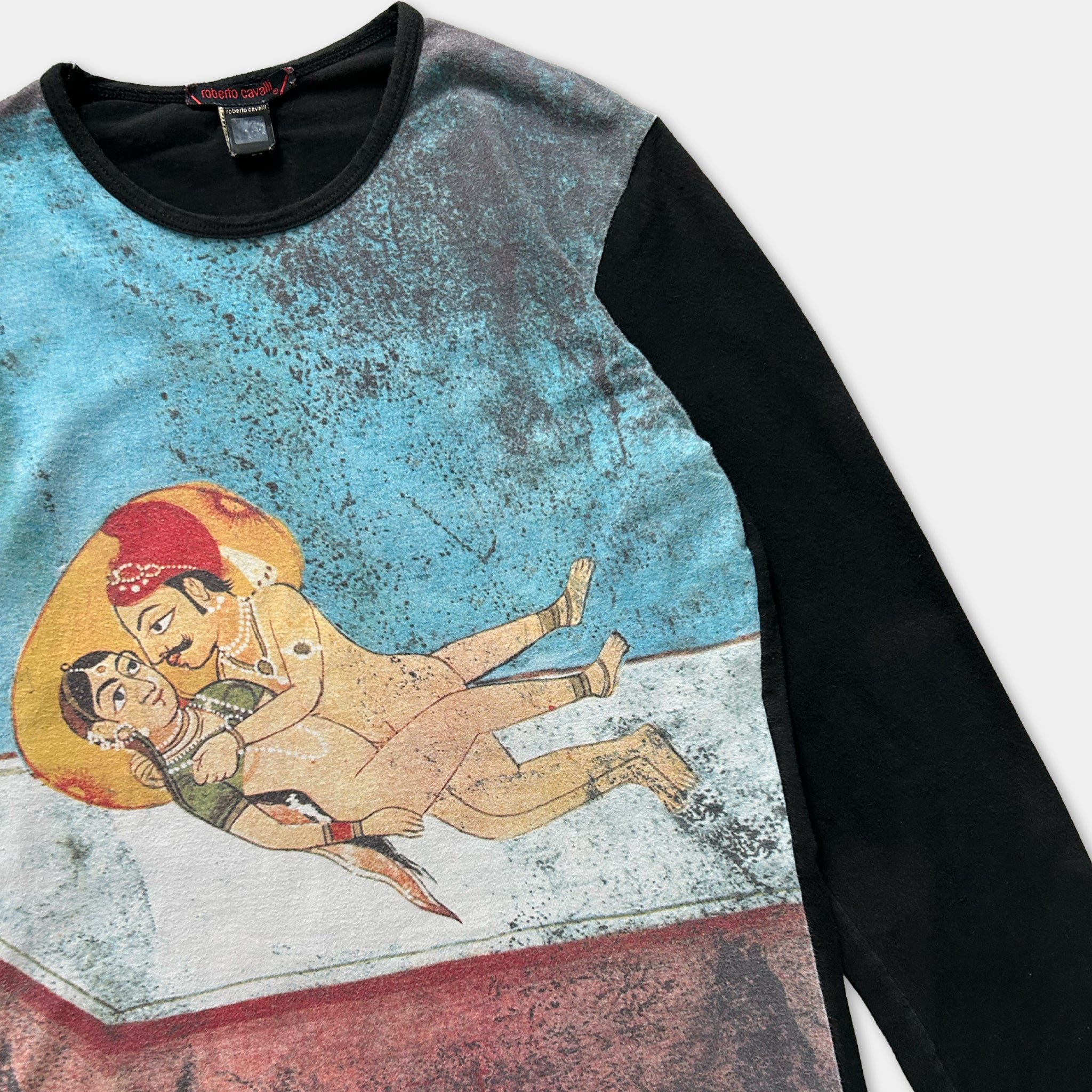 a colorful printed shirt with a graphic design depicting a couple embracing.