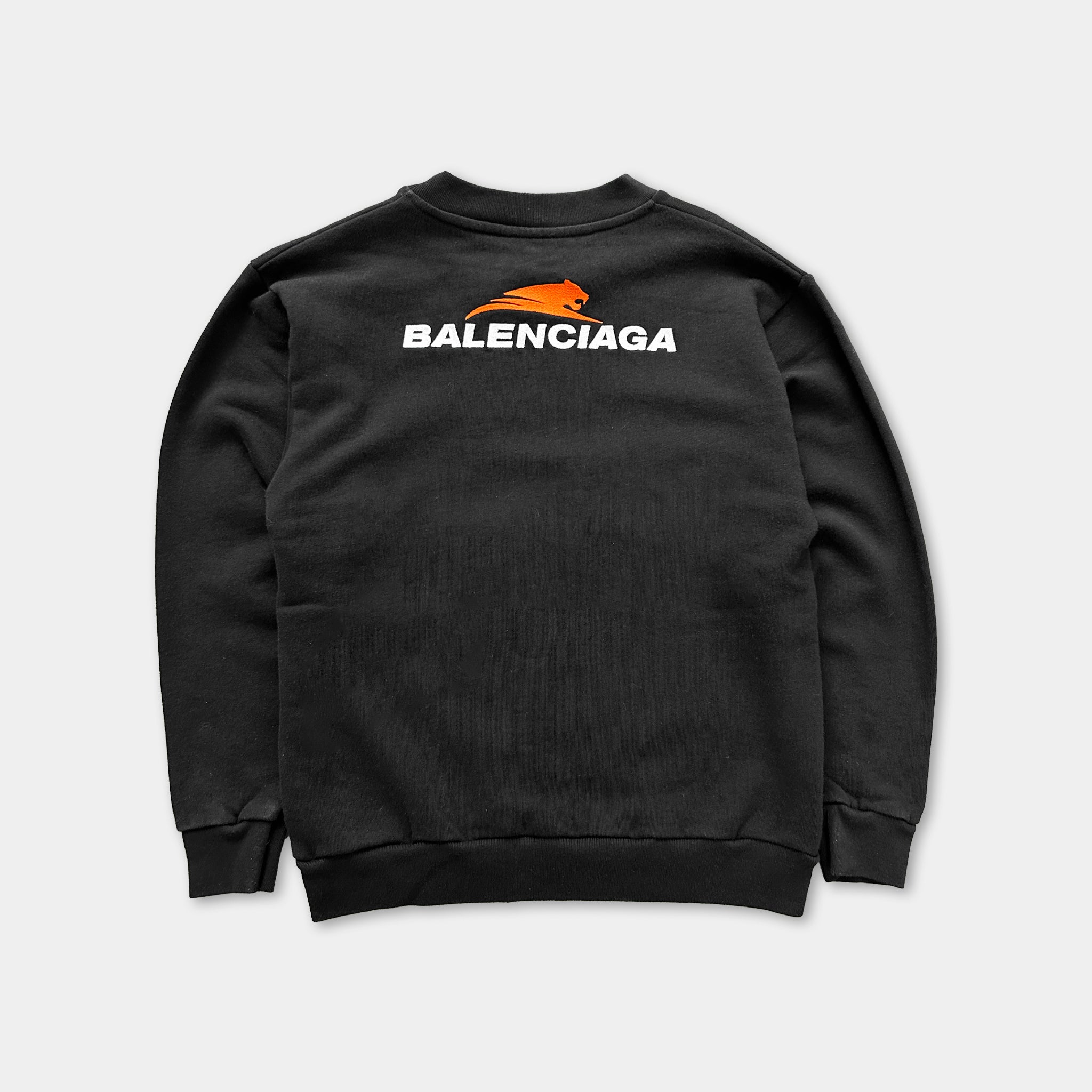 A black sweatshirt with the word "BALENCIAGA" printed on the back in white text.