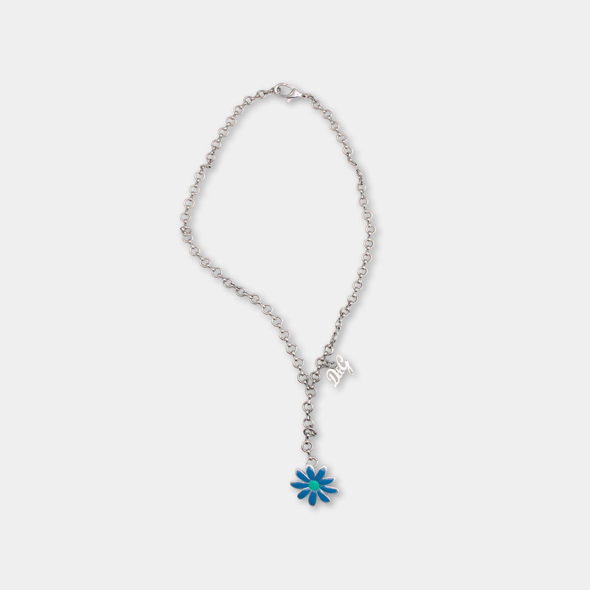 A silver necklace with a blue flower charm hanging from it.