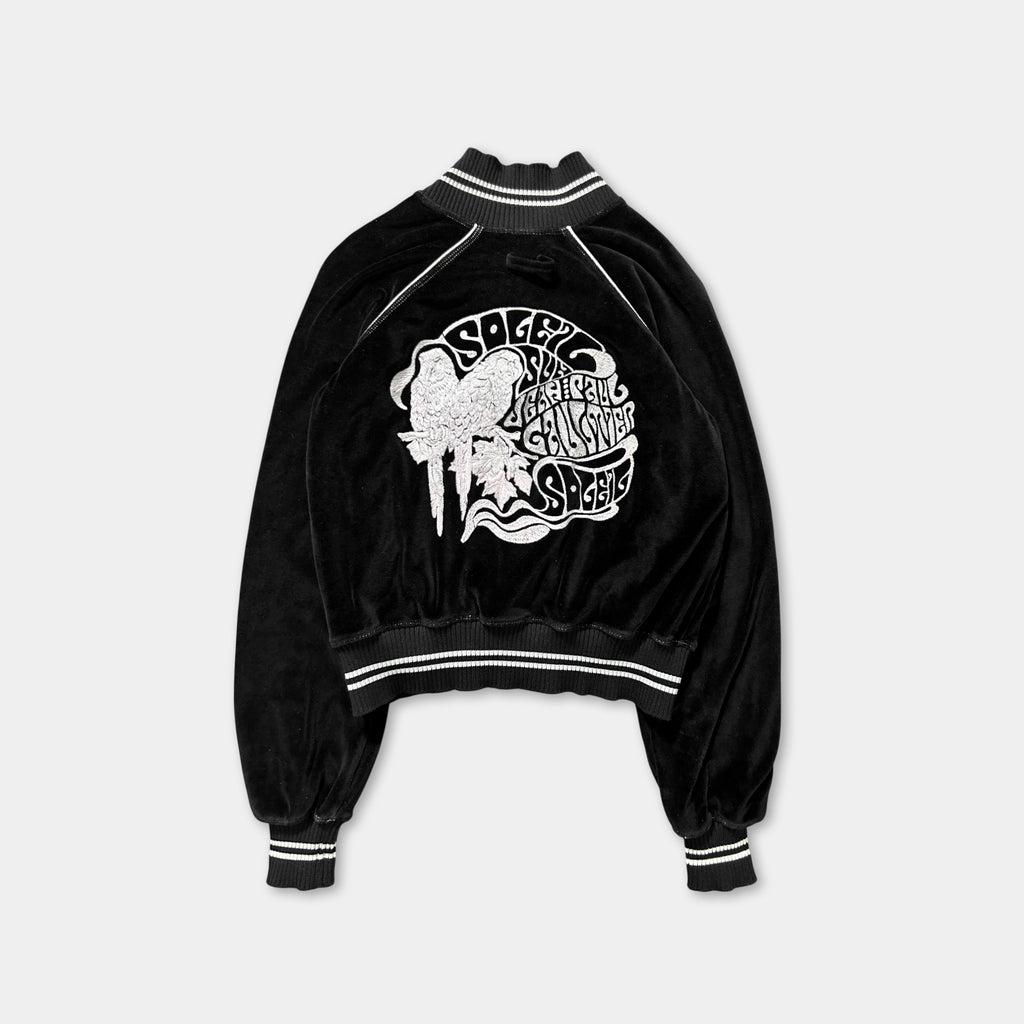 A black velvet jacket with a white graphic design on the back.