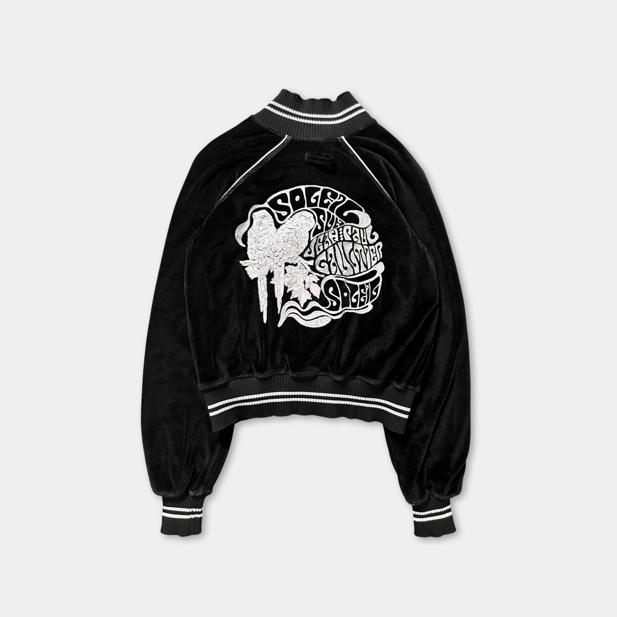 A black velvet jacket with a white graphic design on the back.