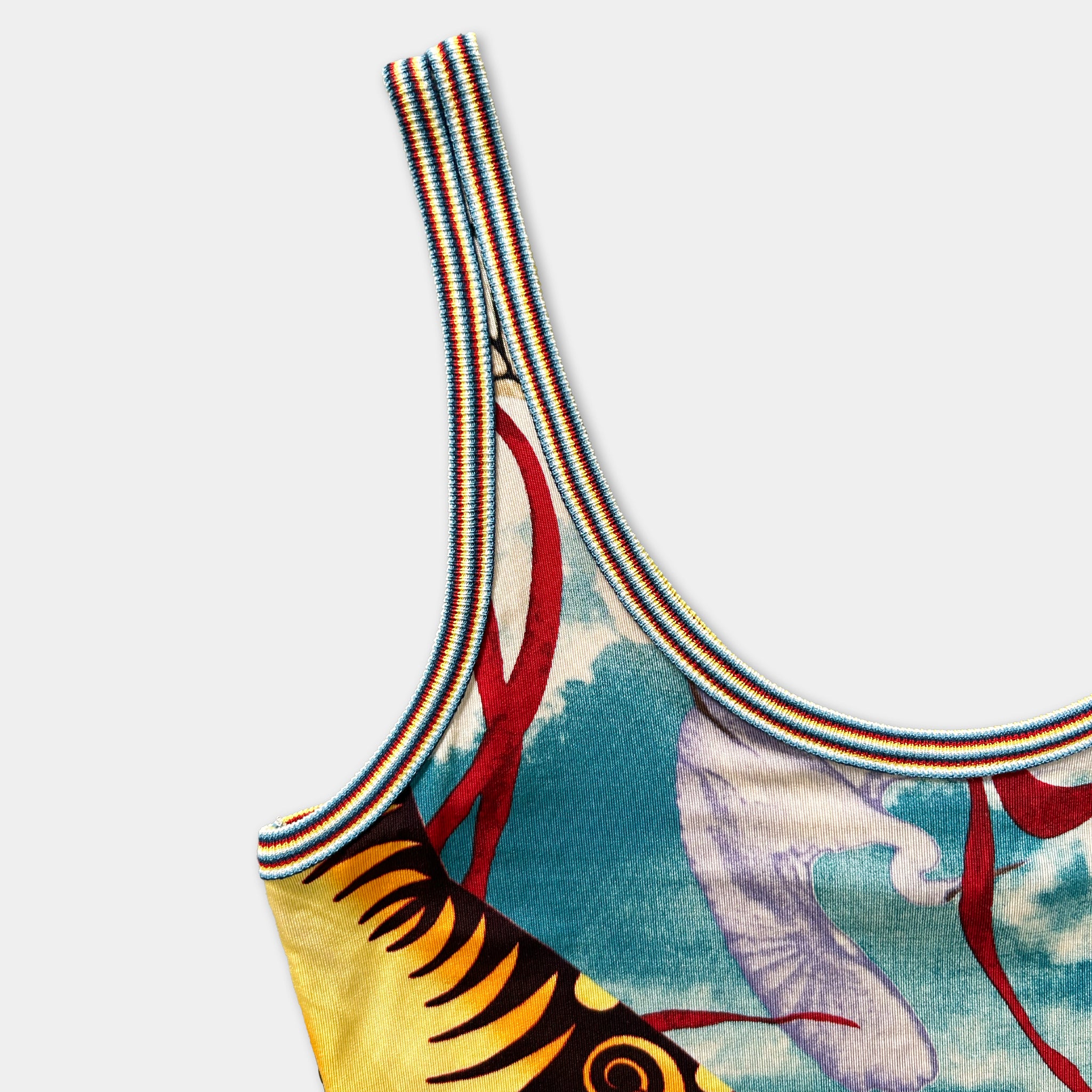a colorful tank top with a vibrant pattern of stripes and designs.
