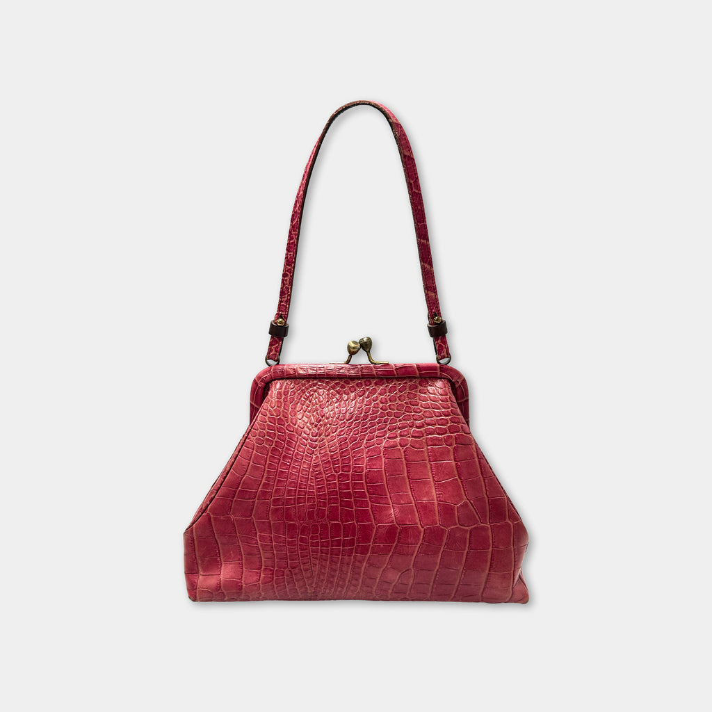 A red leather handbag with a crocodile skin texture and a gold clasp.