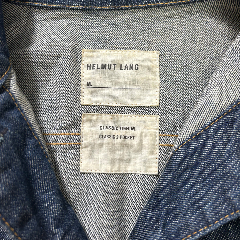 the inside of a denim jacket, featuring a label and a pocket tag.