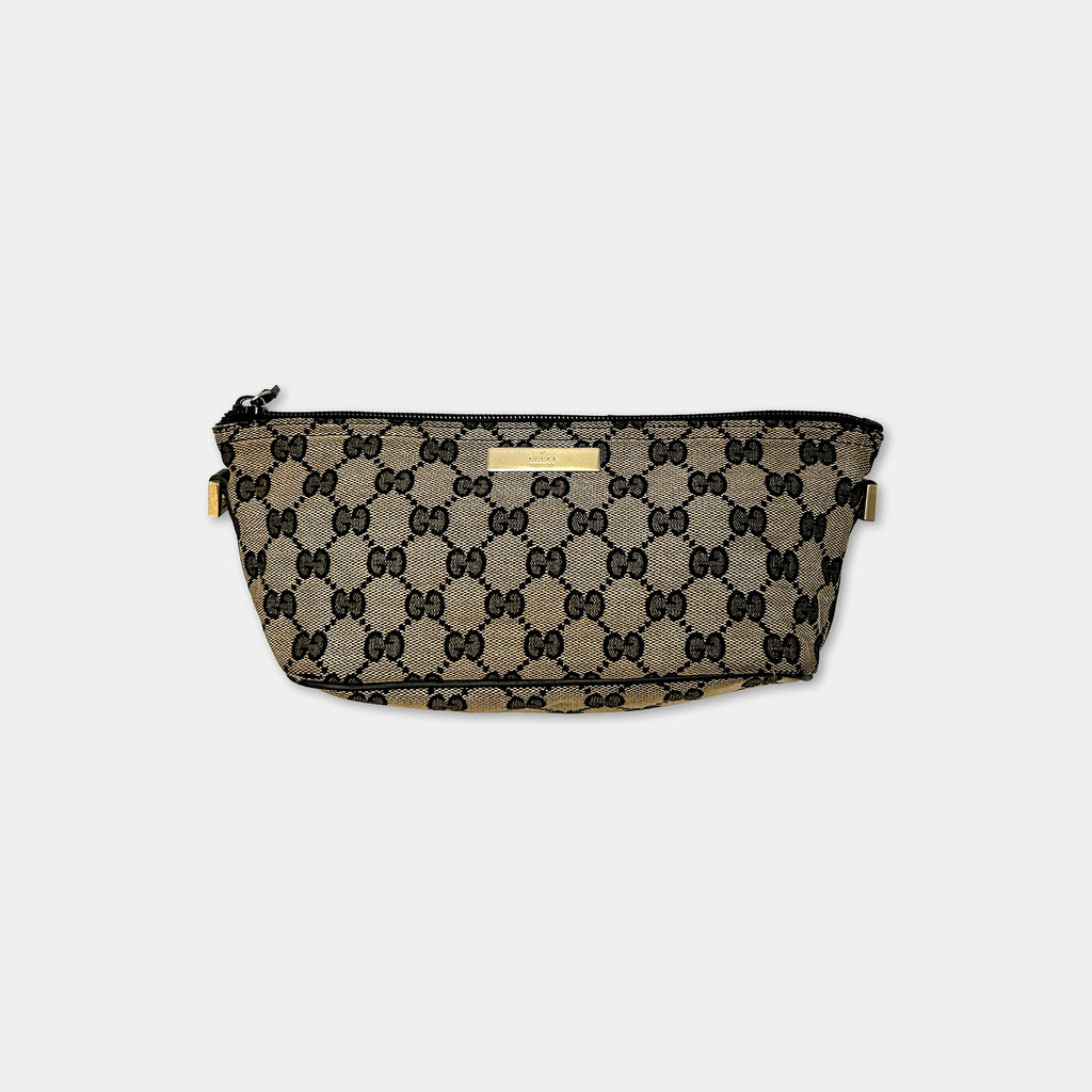 A black and gold Gucci-patterned bag with a zipper closure and gold hardware.