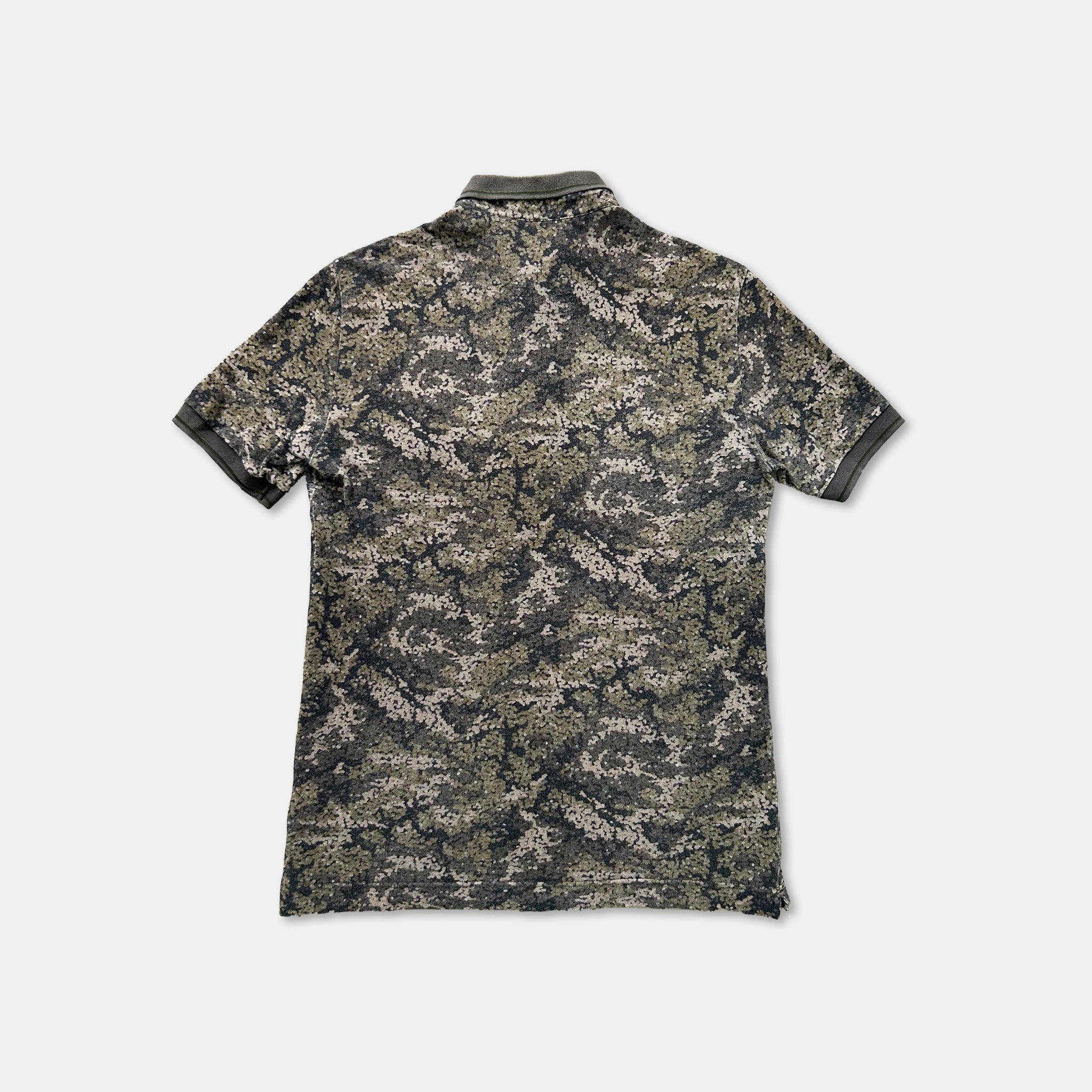 a camouflage patterned short-sleeved polo shirt against a white background.
