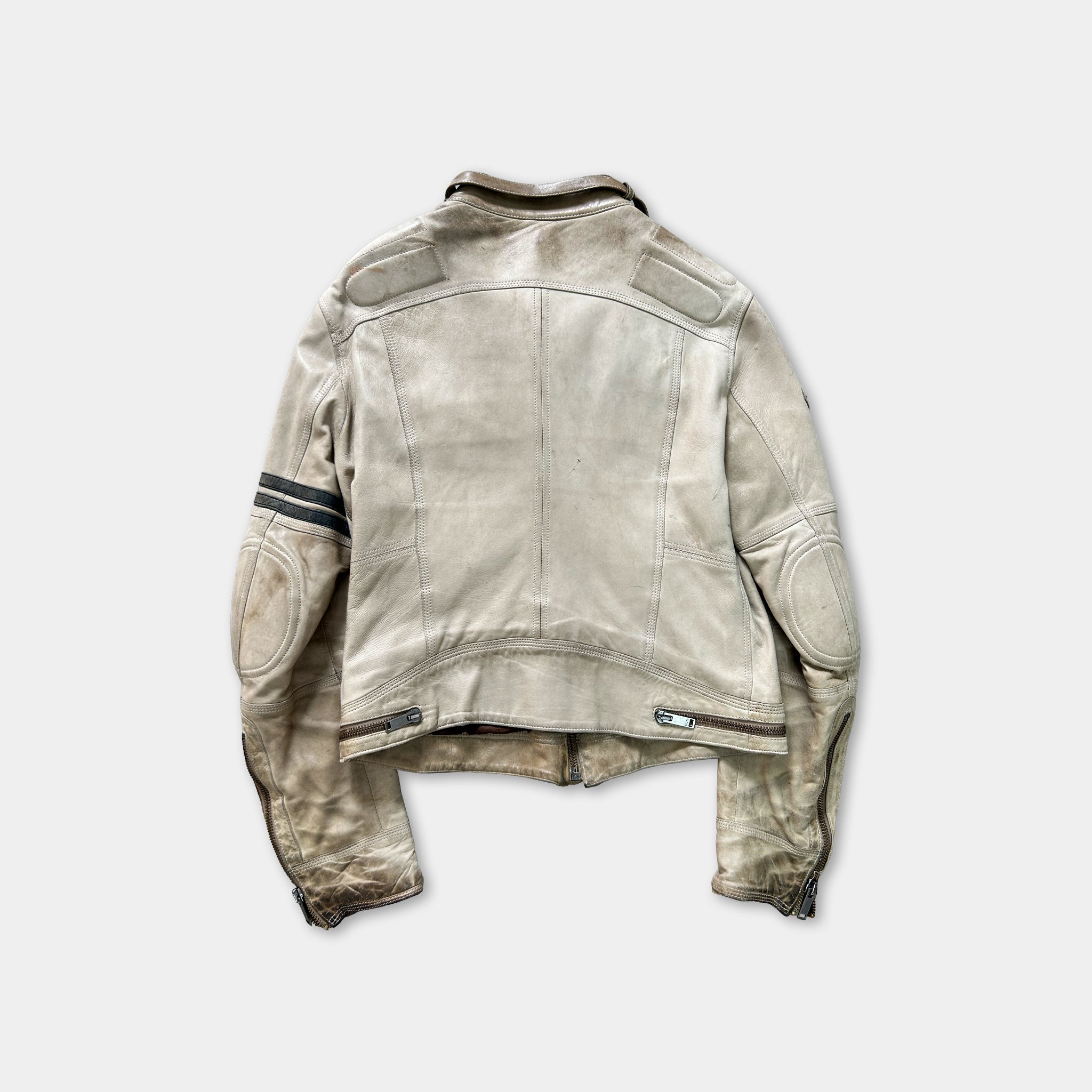 A worn, light-colored leather jacket with a collar and two pockets, hanging against a plain background.