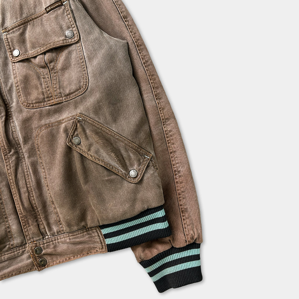 A brown jacket with a zipper and pockets, featuring a striped sleeve.