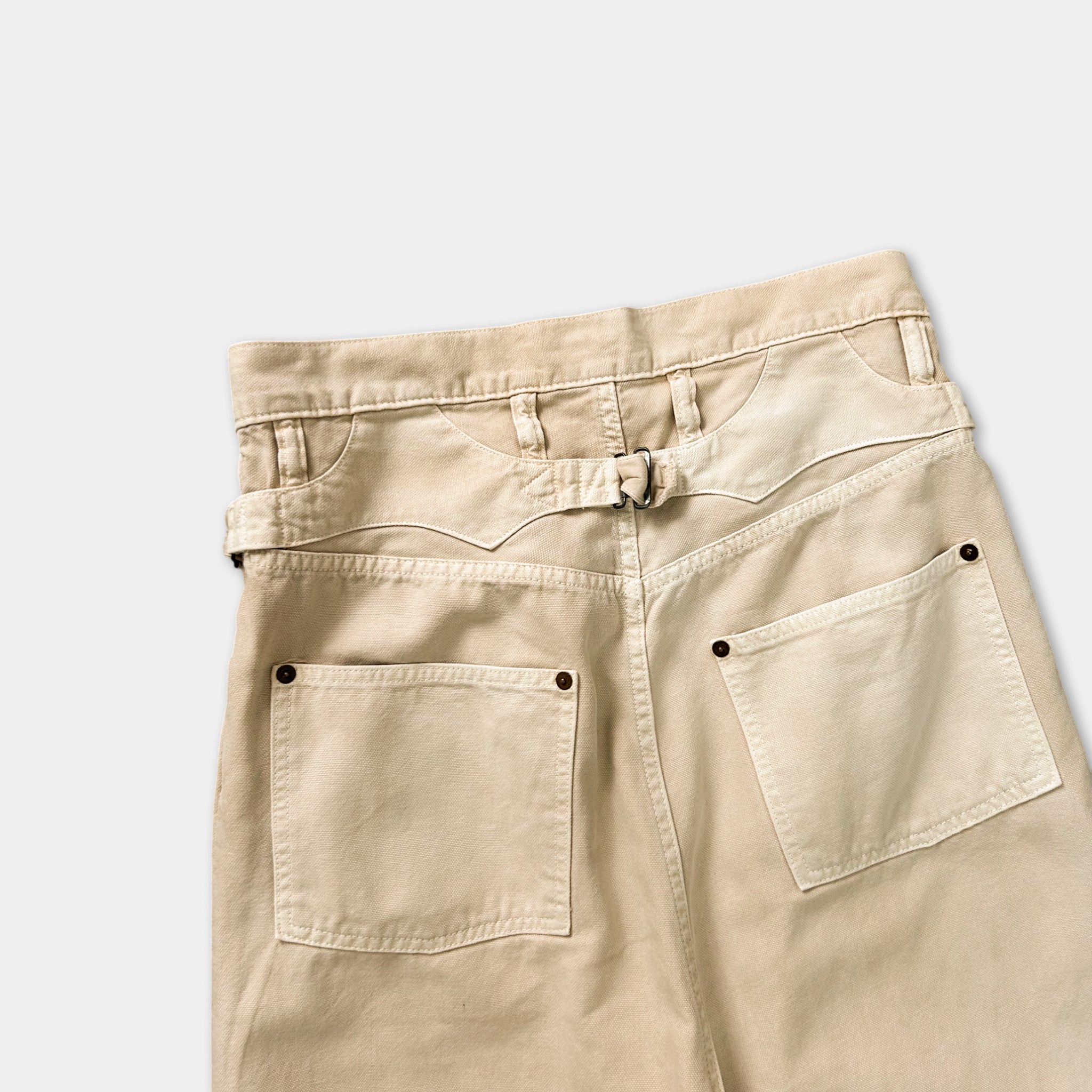 A pair of khaki-colored cargo pants with multiple pockets and a belt.