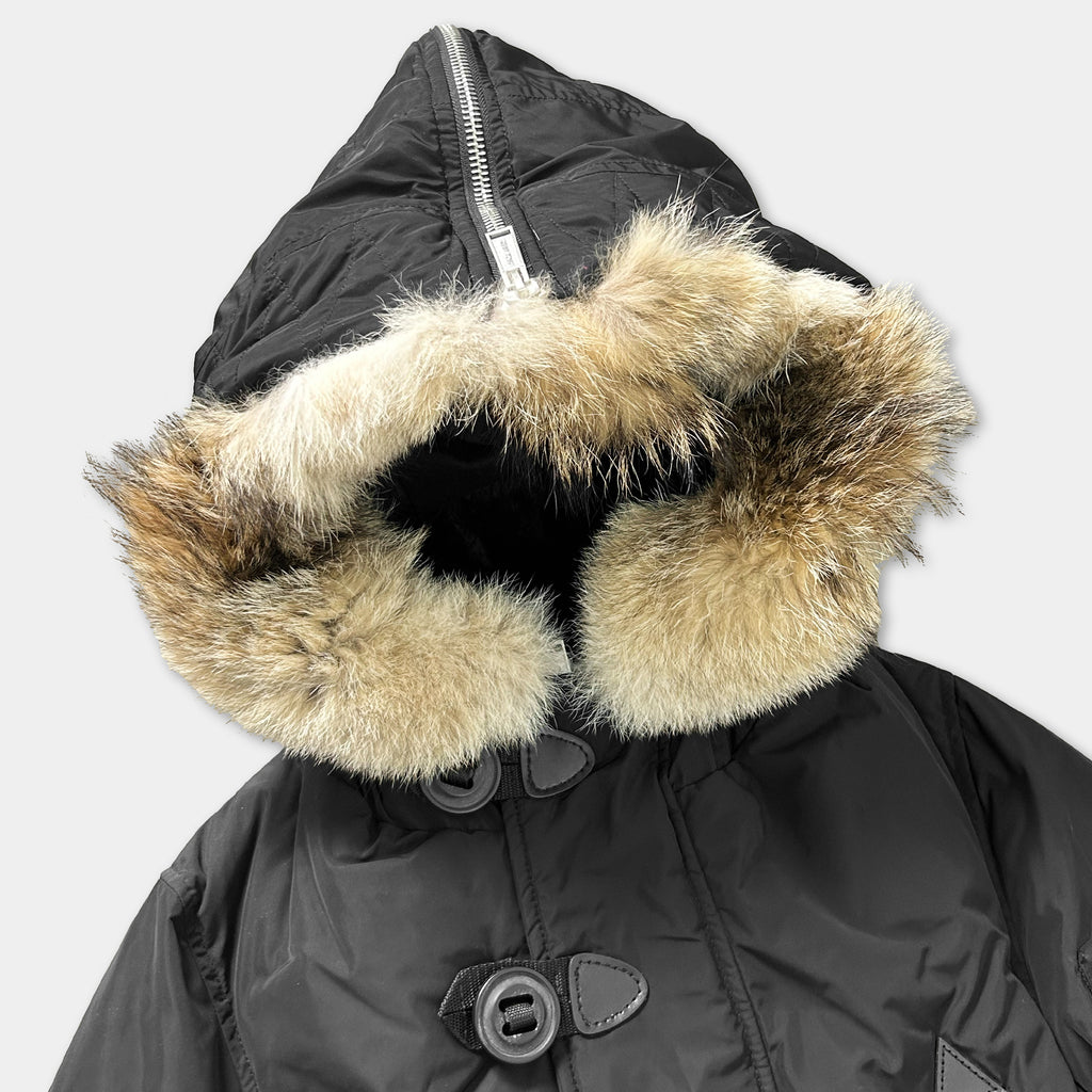 A black winter coat with a fur-lined hood and zipper.