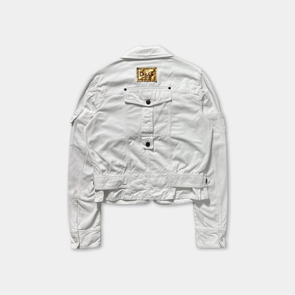 A white denim jacket with a gold logo on the back.