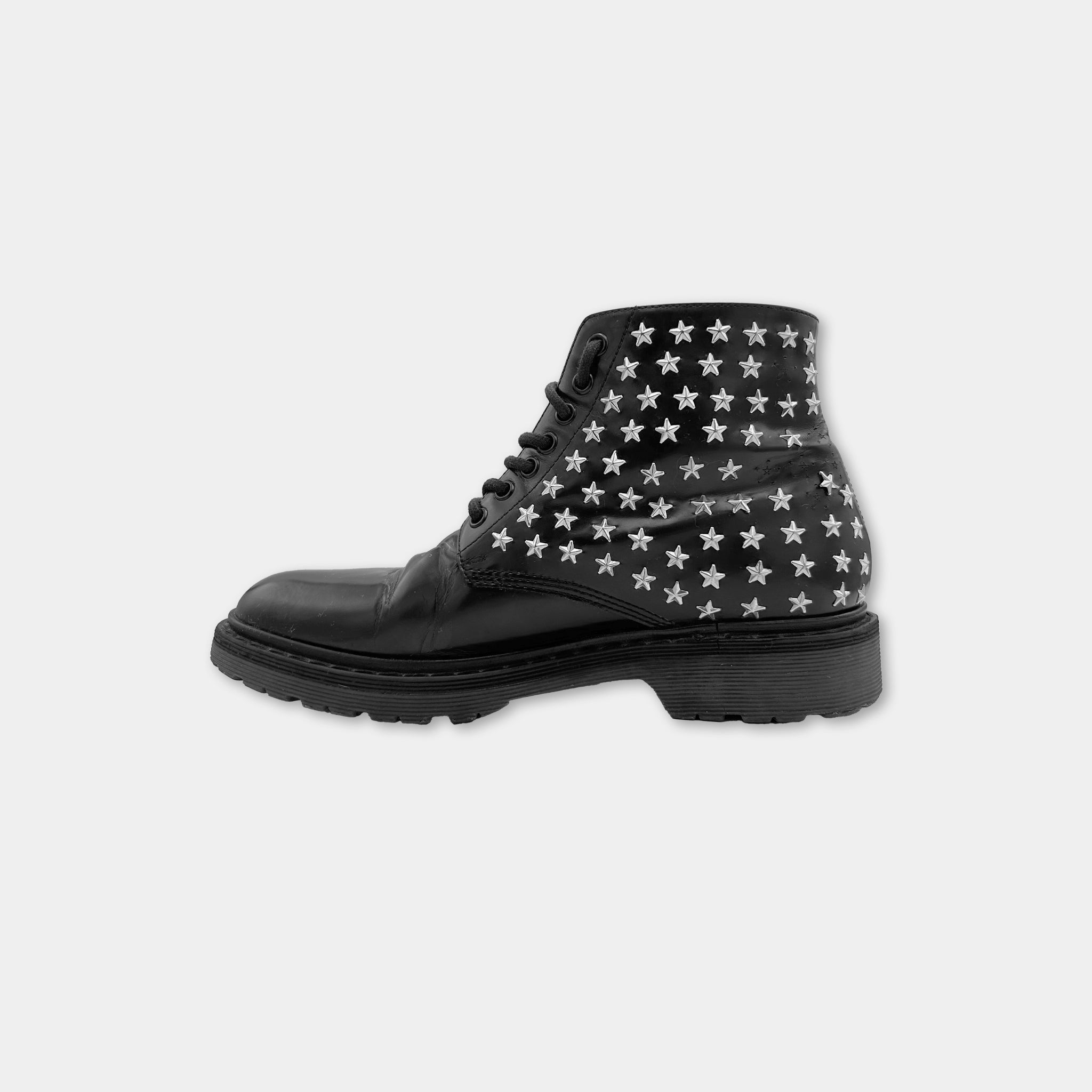 A black leather boot with white star patterns on the side.