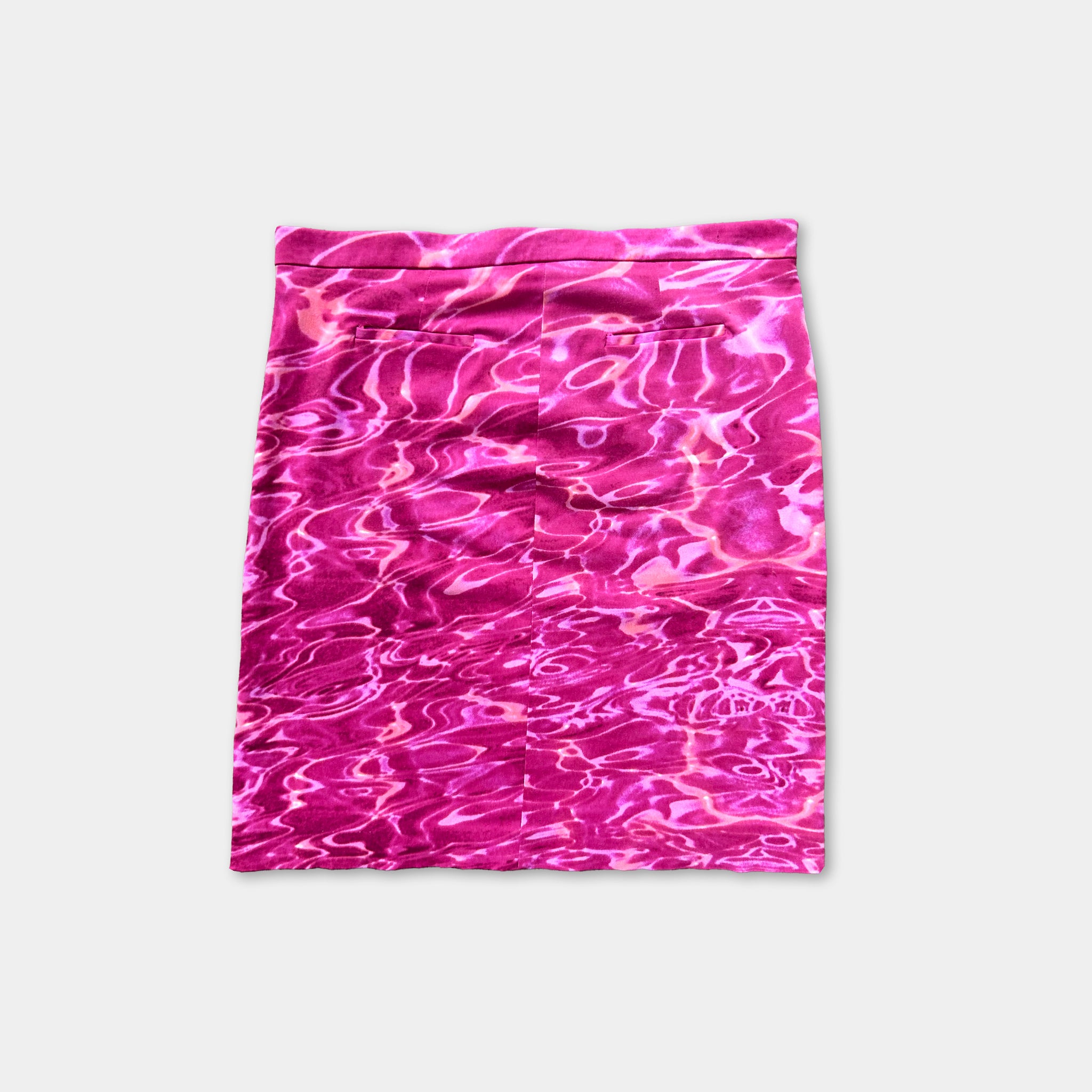 A pink, water-like patterned skirt is shown against a white background.
