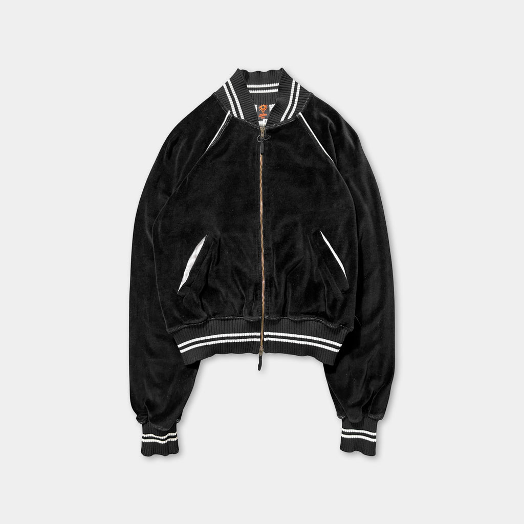 A black velvet jacket with white stripes, featuring a zipper and two pockets.