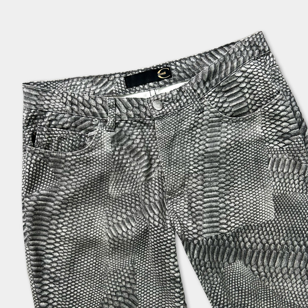 A pair of black and white patterned jeans with a distinctive snake skin design.