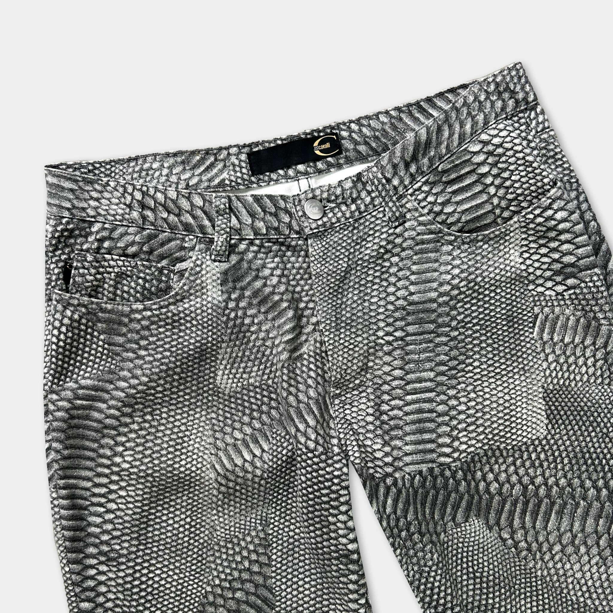 A pair of black and white patterned jeans with a distinctive snake skin design.
