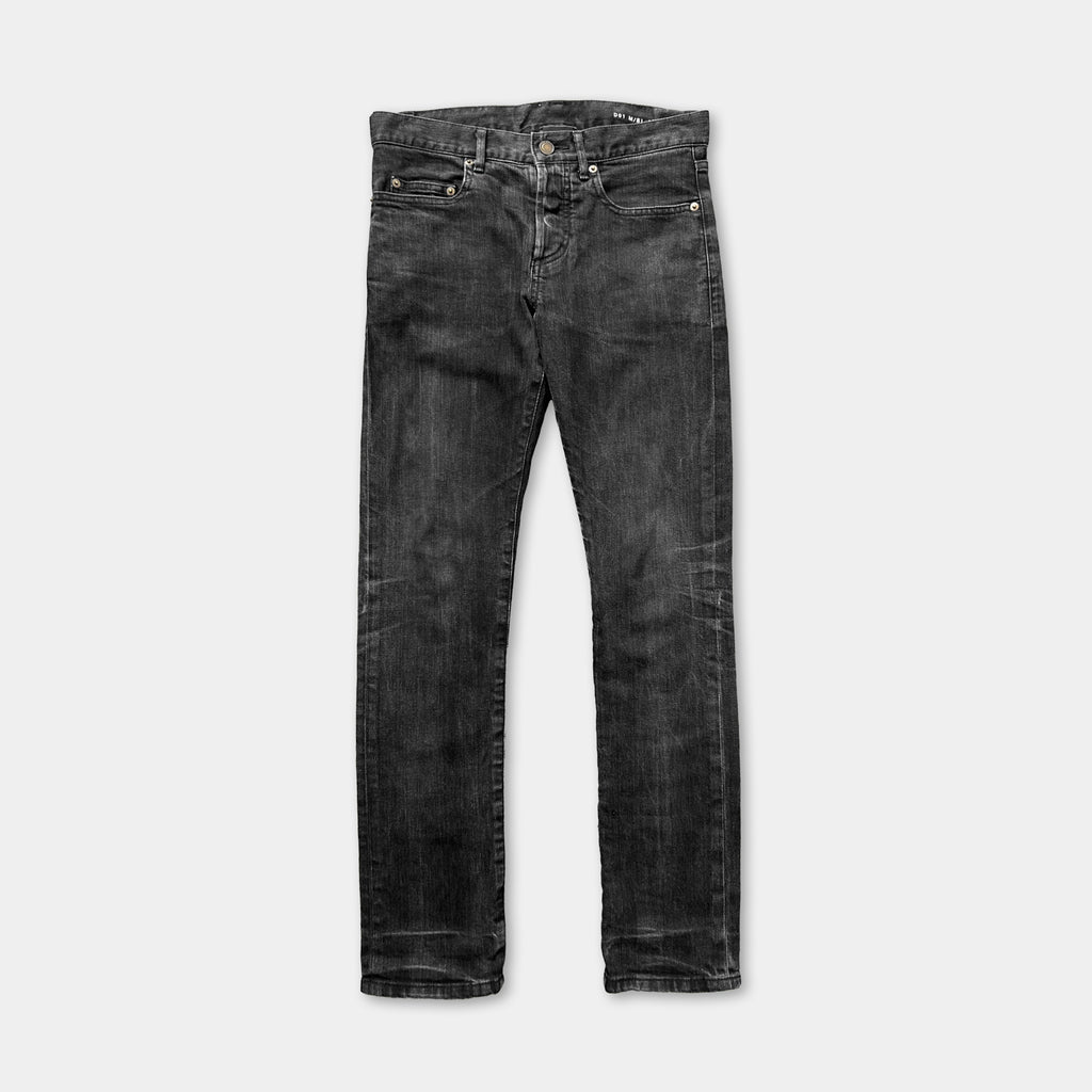 A pair of black skinny jeans with a button closure.