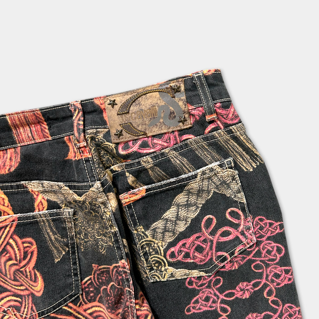 a pair of black jeans with a colorful, printed pattern on the fabric.