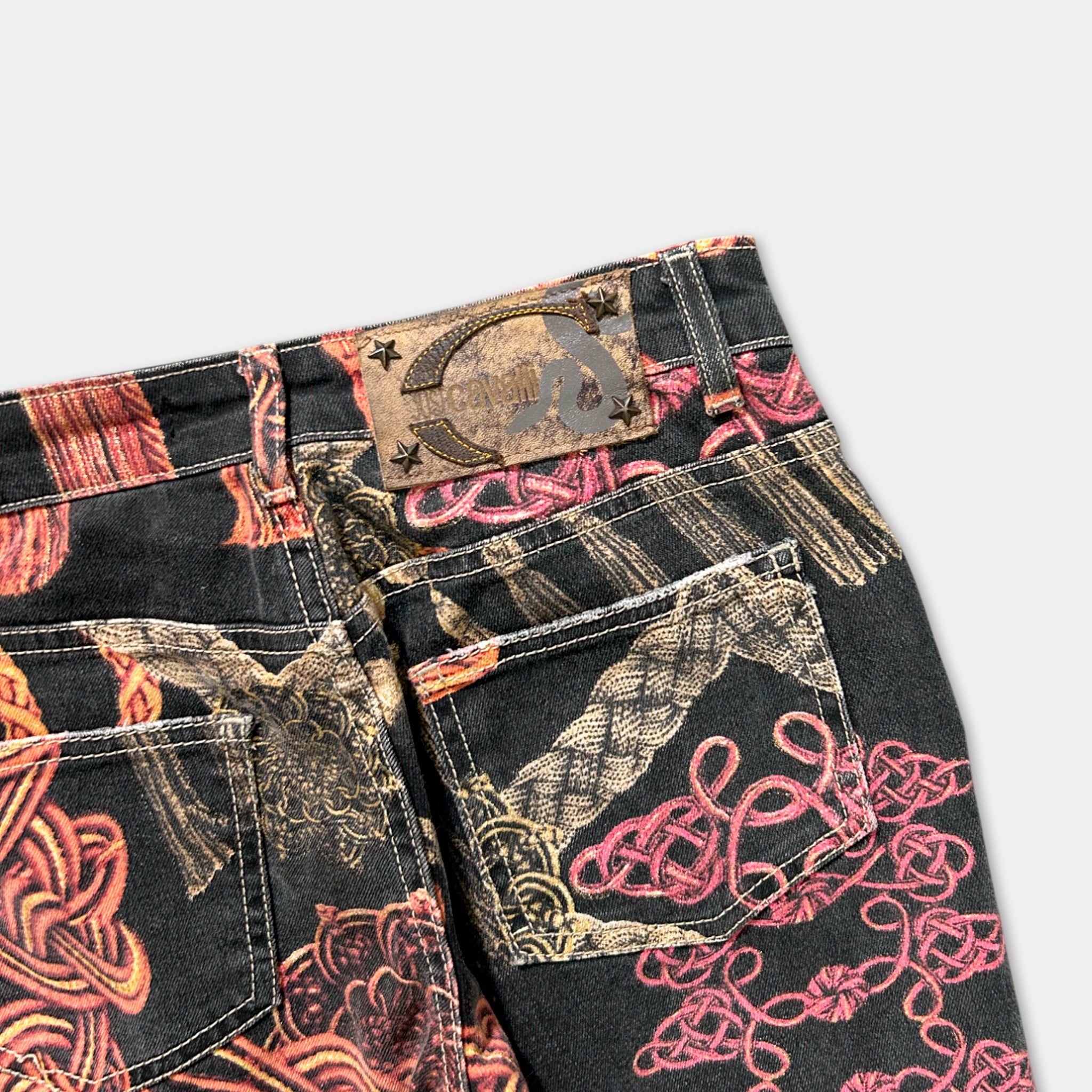 a pair of black jeans with a colorful, printed pattern on the fabric.