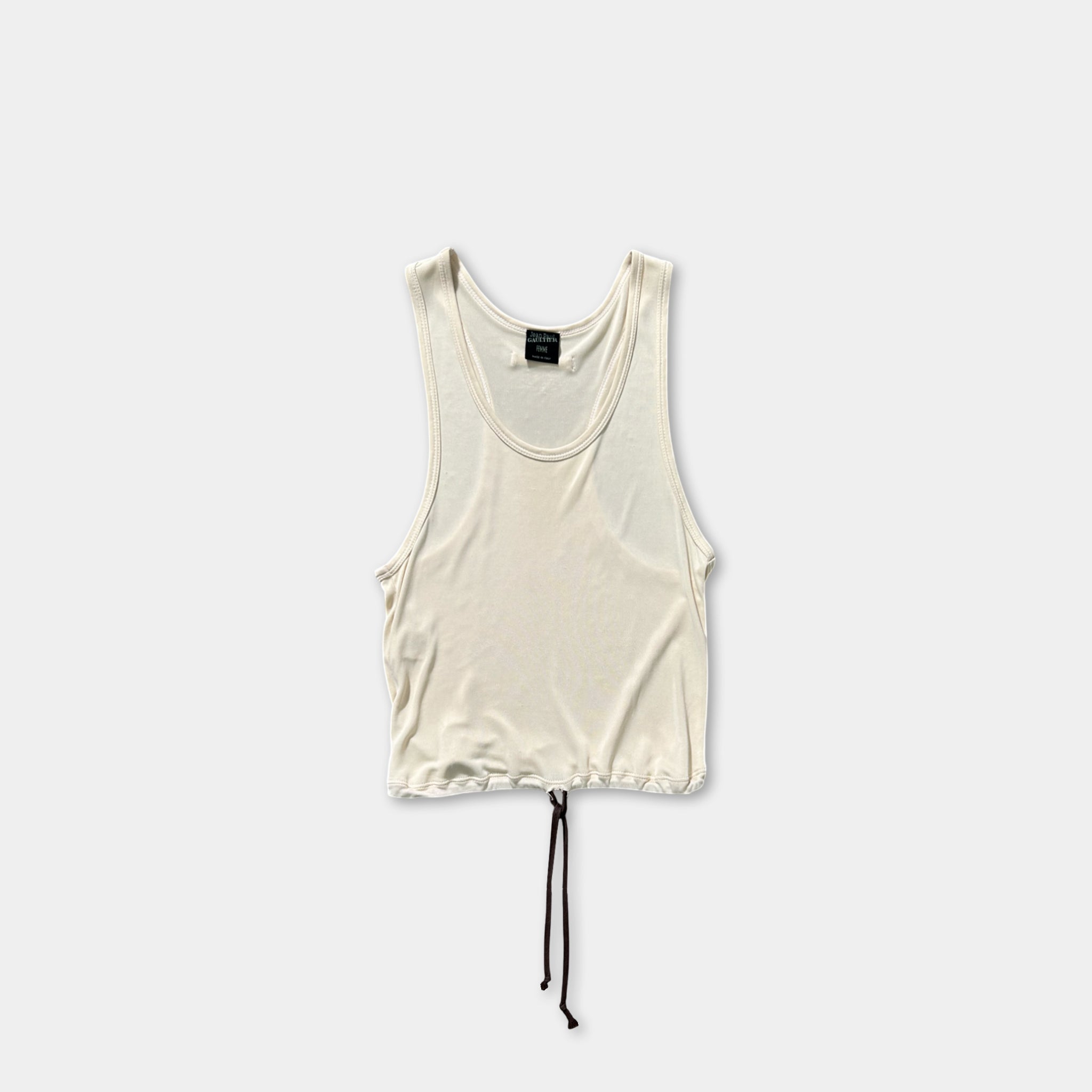 A white tank top with a drawstring waist and a black tie at the bottom is shown against a plain white background.