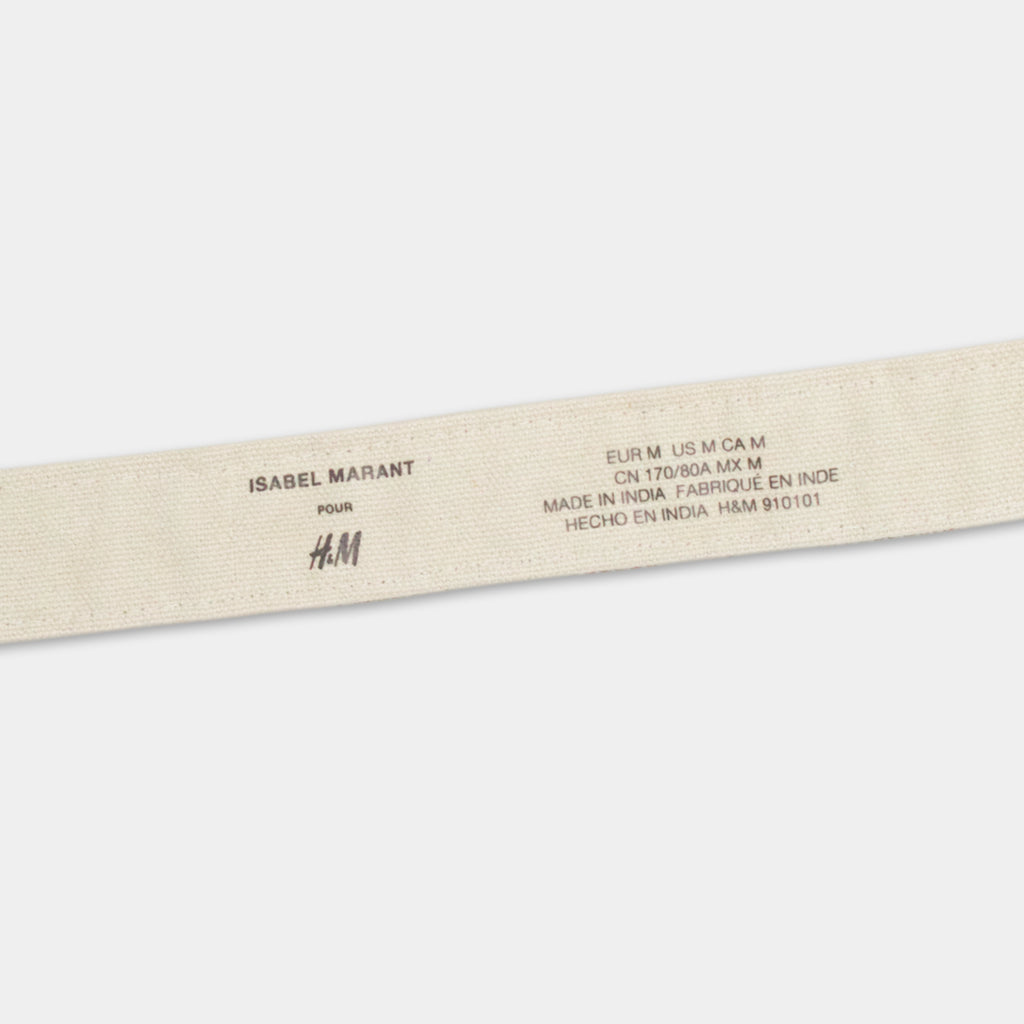 a beige fabric with text printed on it, which appears to be a label or tag for a product.
