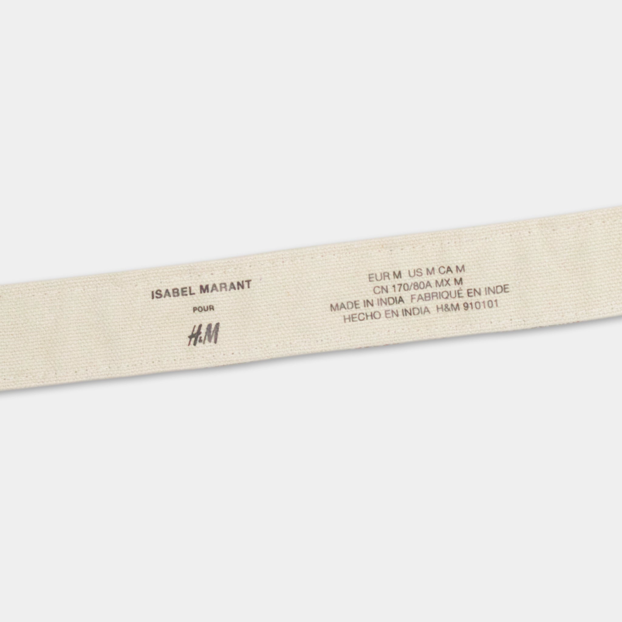 a beige fabric with text printed on it, which appears to be a label or tag for a product.