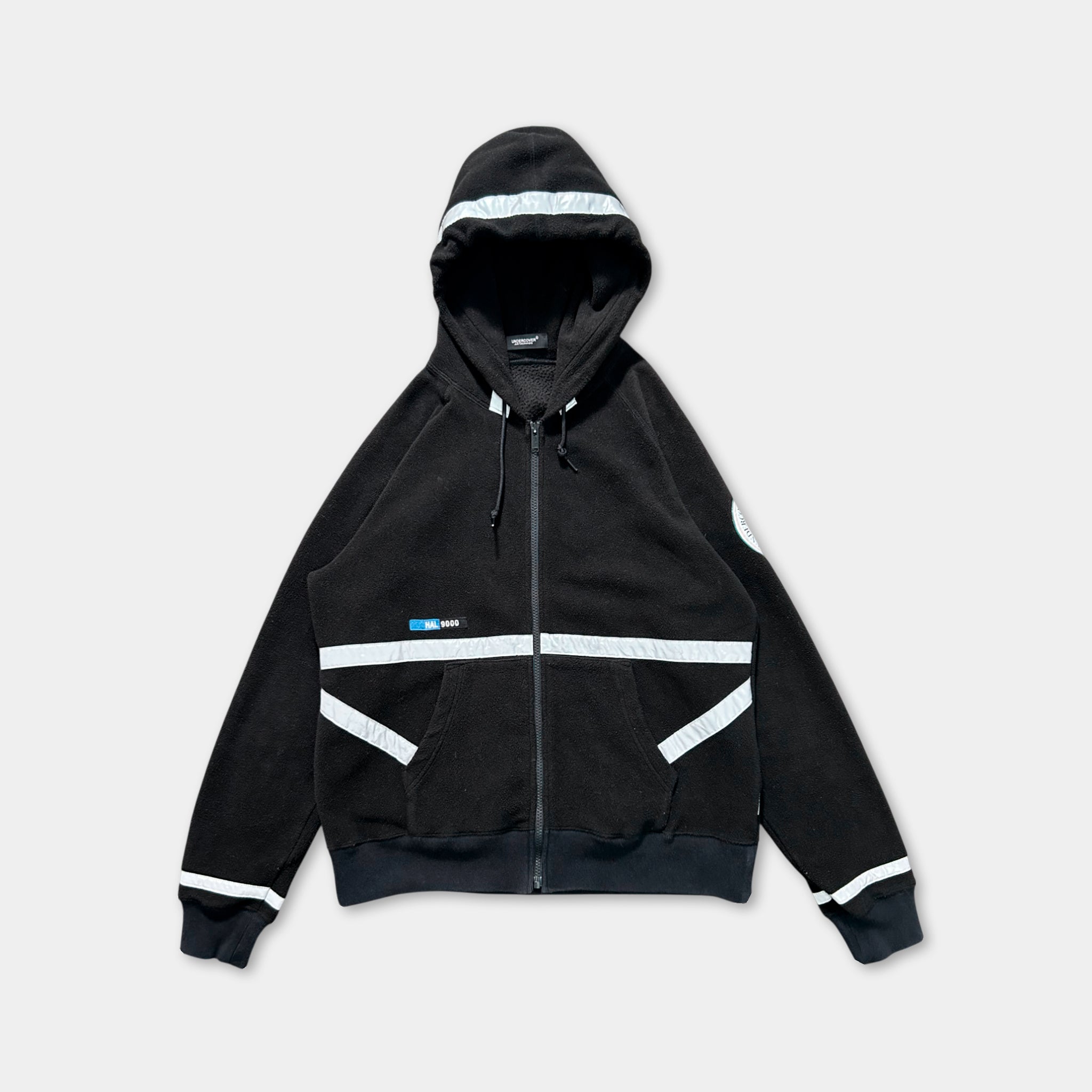 A black hooded zip-up jacket with white stripes on the sleeves and front.