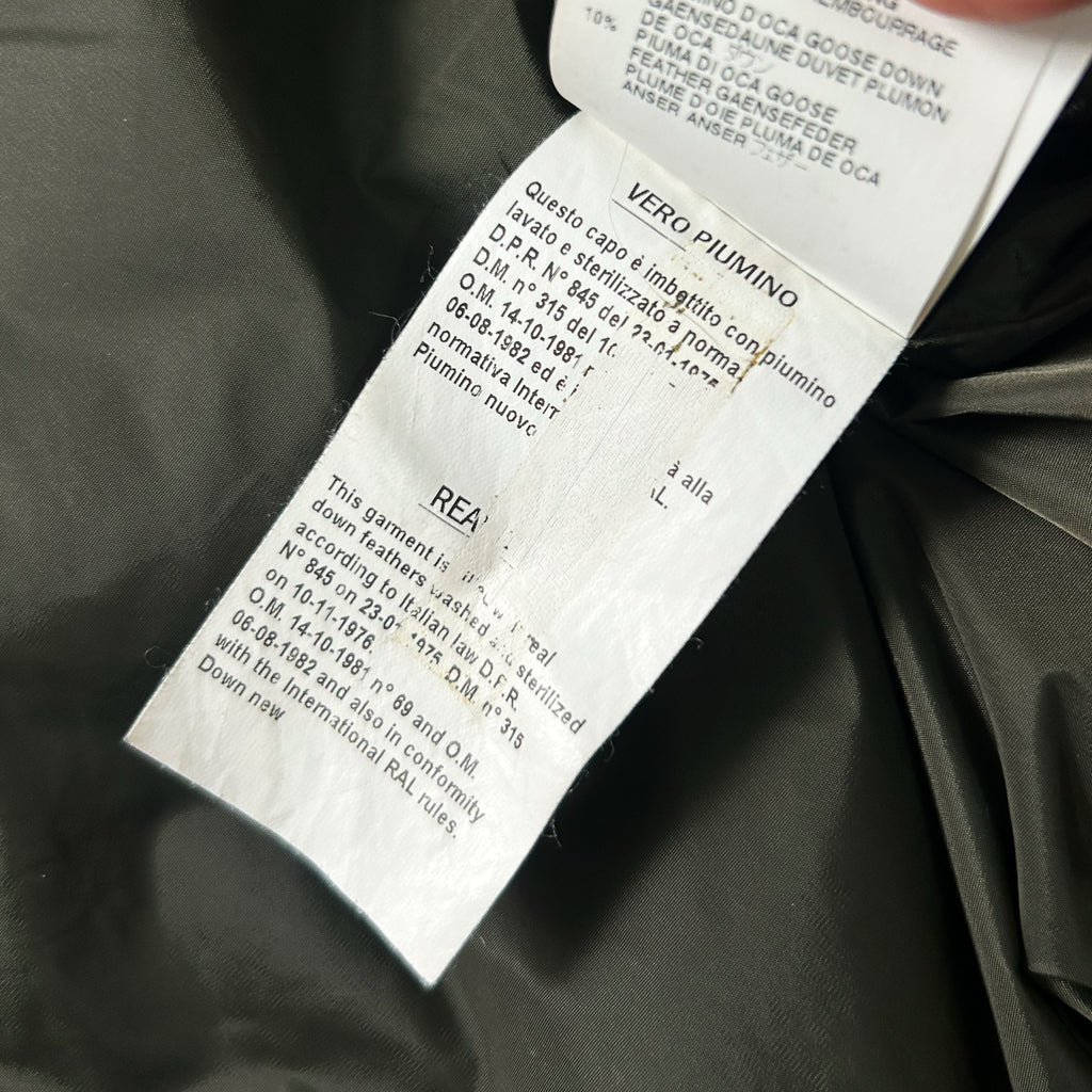 a close-up view of a label on a piece of clothing, with text and details about the garment.