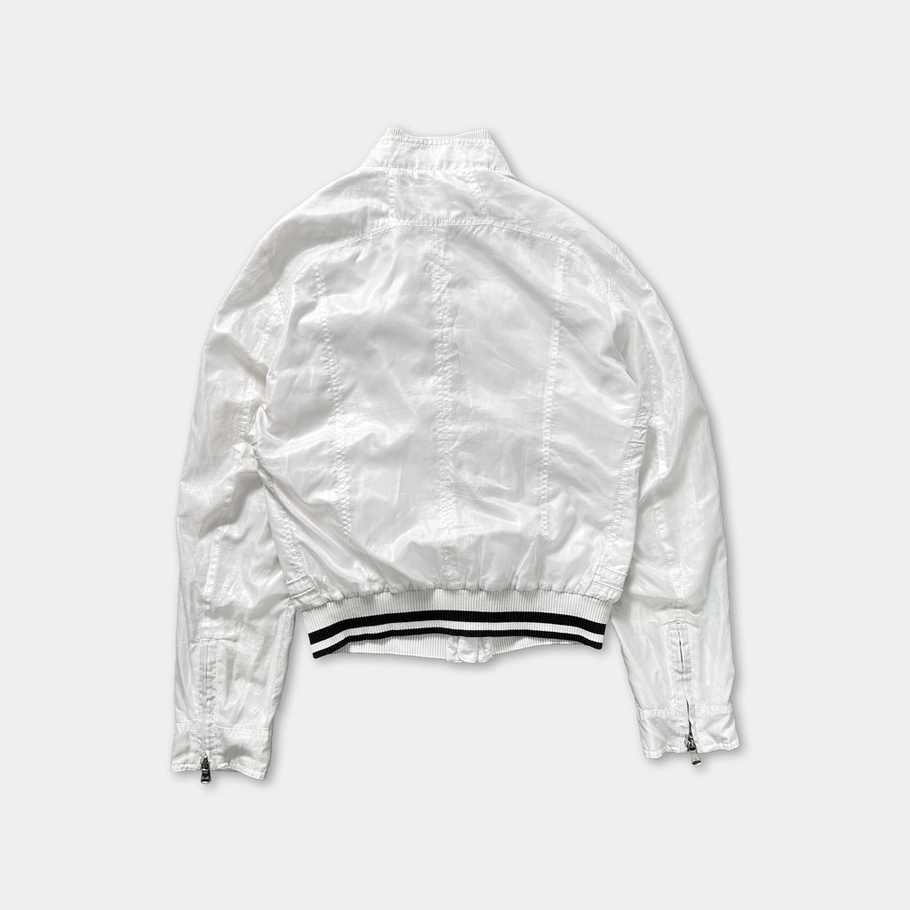 A white jacket with black stripes on the waistband.