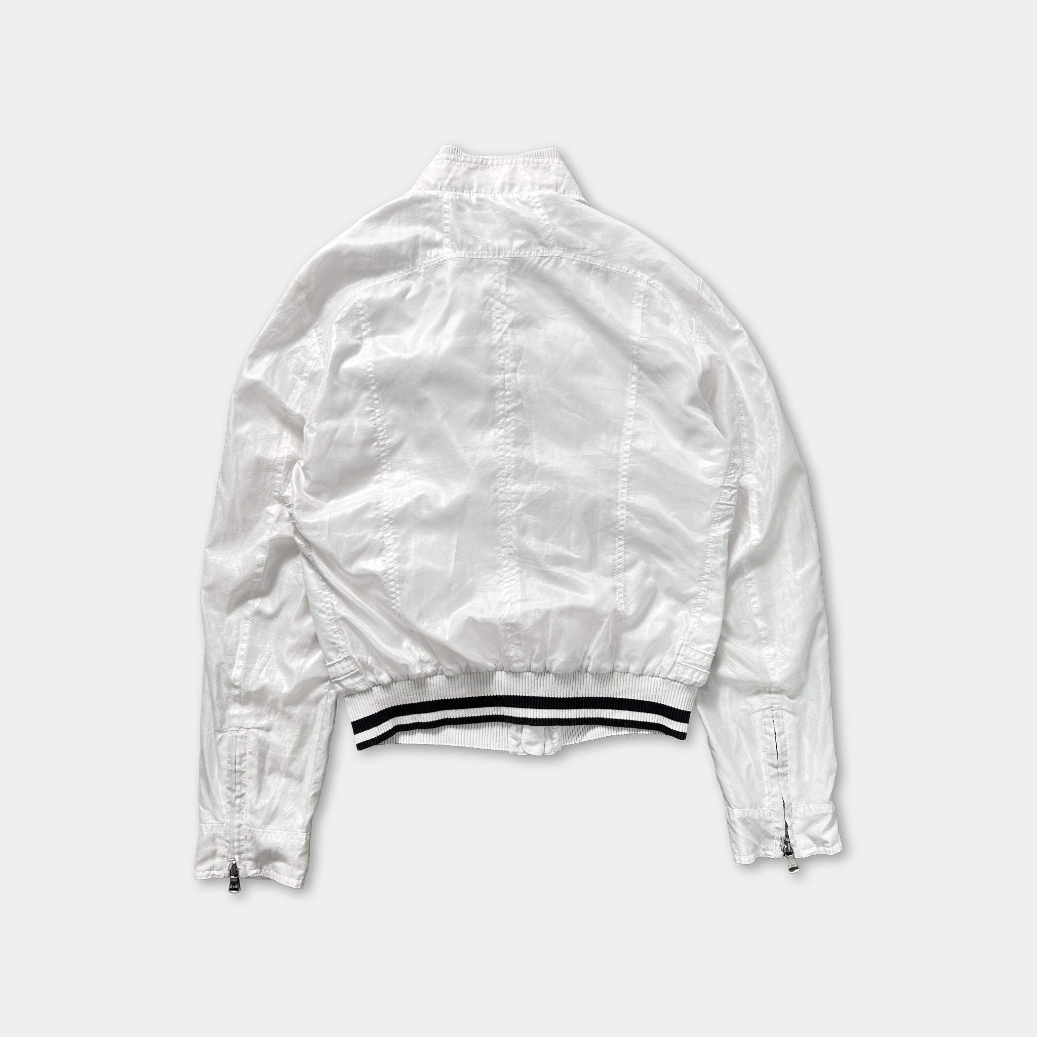 A white jacket with black stripes on the waistband.