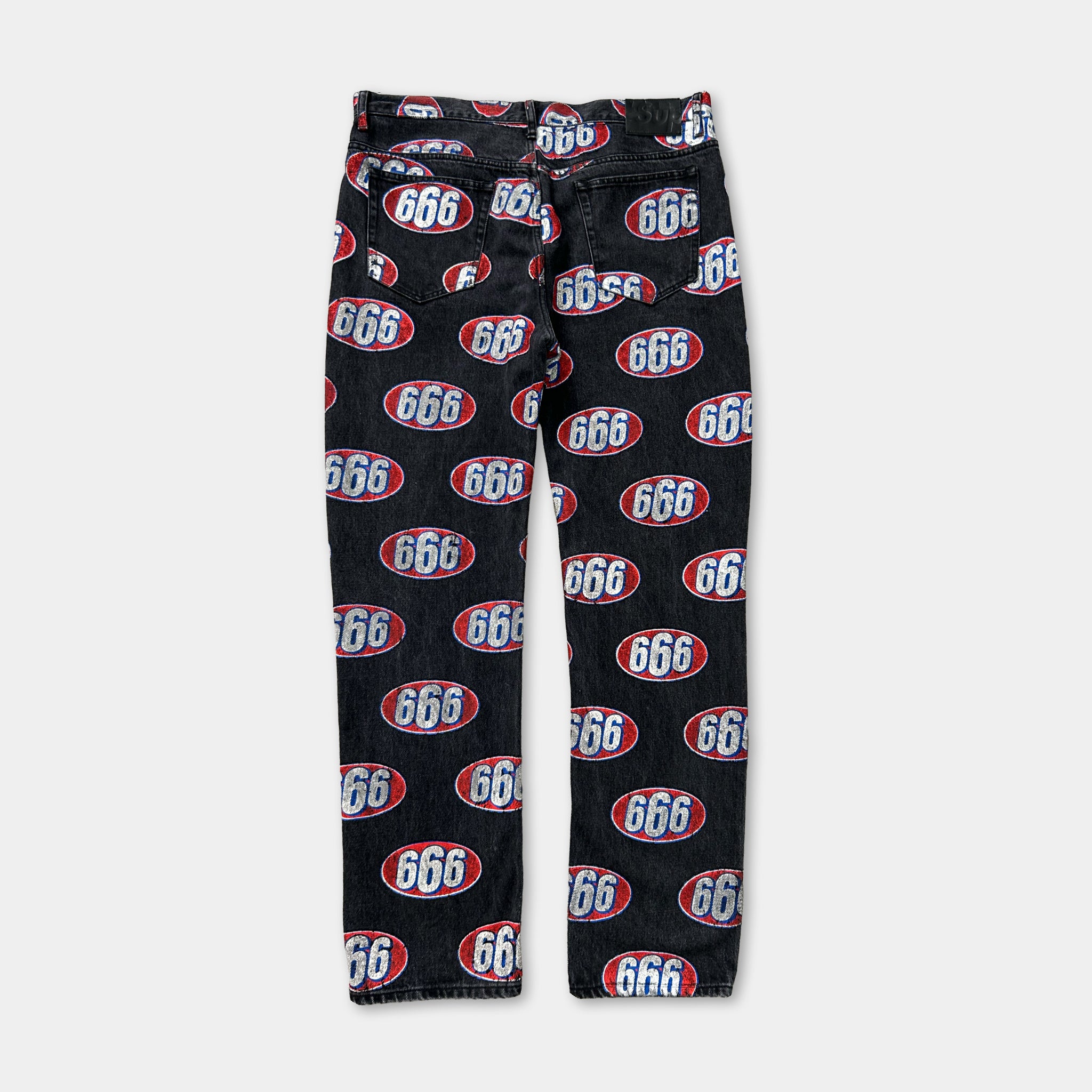 A pair of black jeans with a repeating pattern of the number 666 in red and white colors.