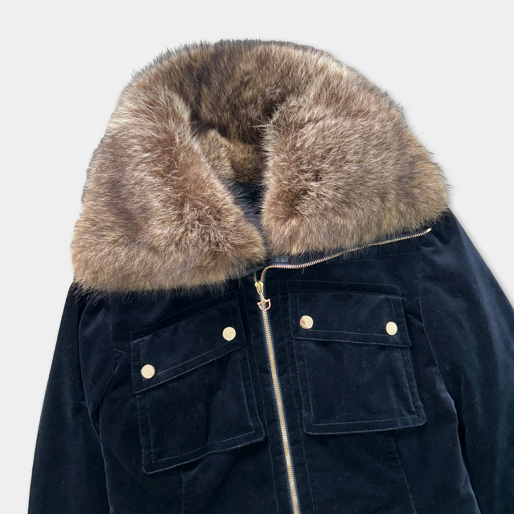 A black velvet jacket with a fur collar and zipper.