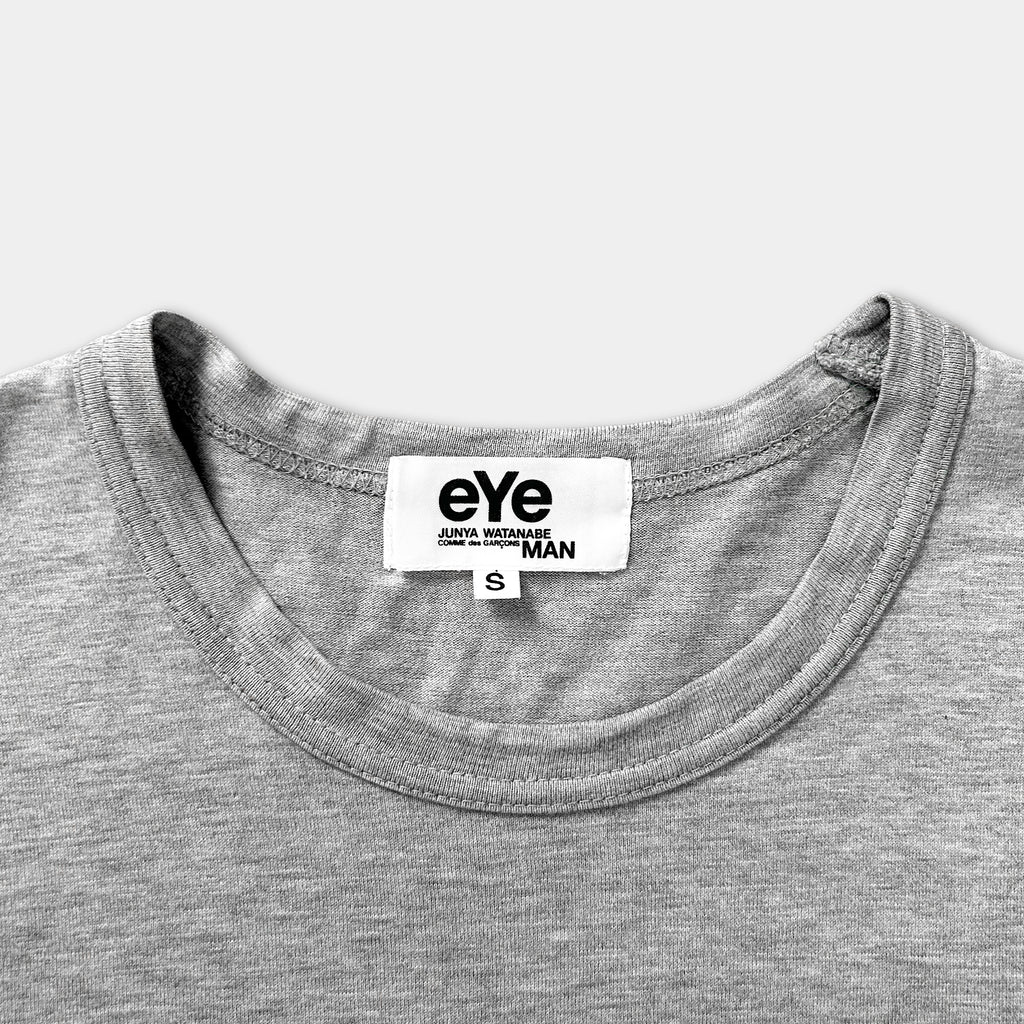 A gray t-shirt with a white label on the collar.