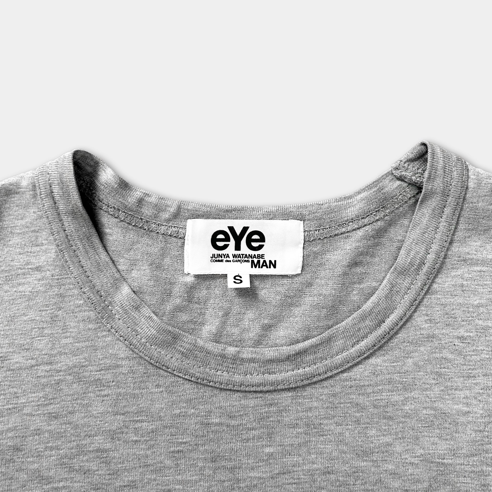 A gray t-shirt with a white label on the collar.