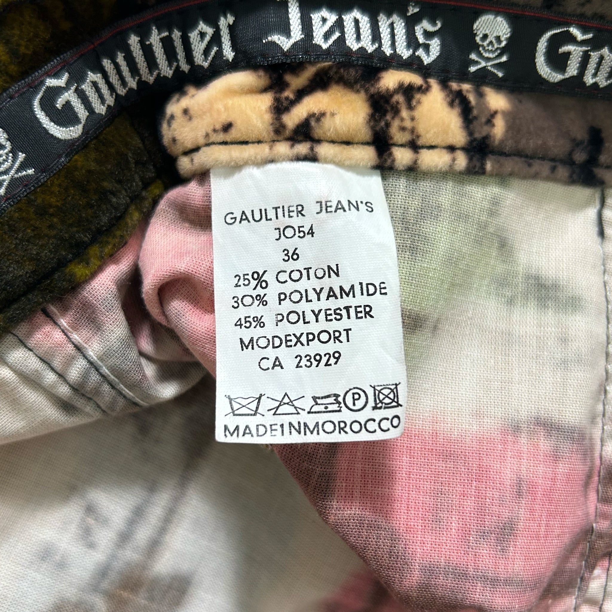 a close-up view of a label on a piece of clothing, likely a pair of jeans, with text detailing the material and care instructions.