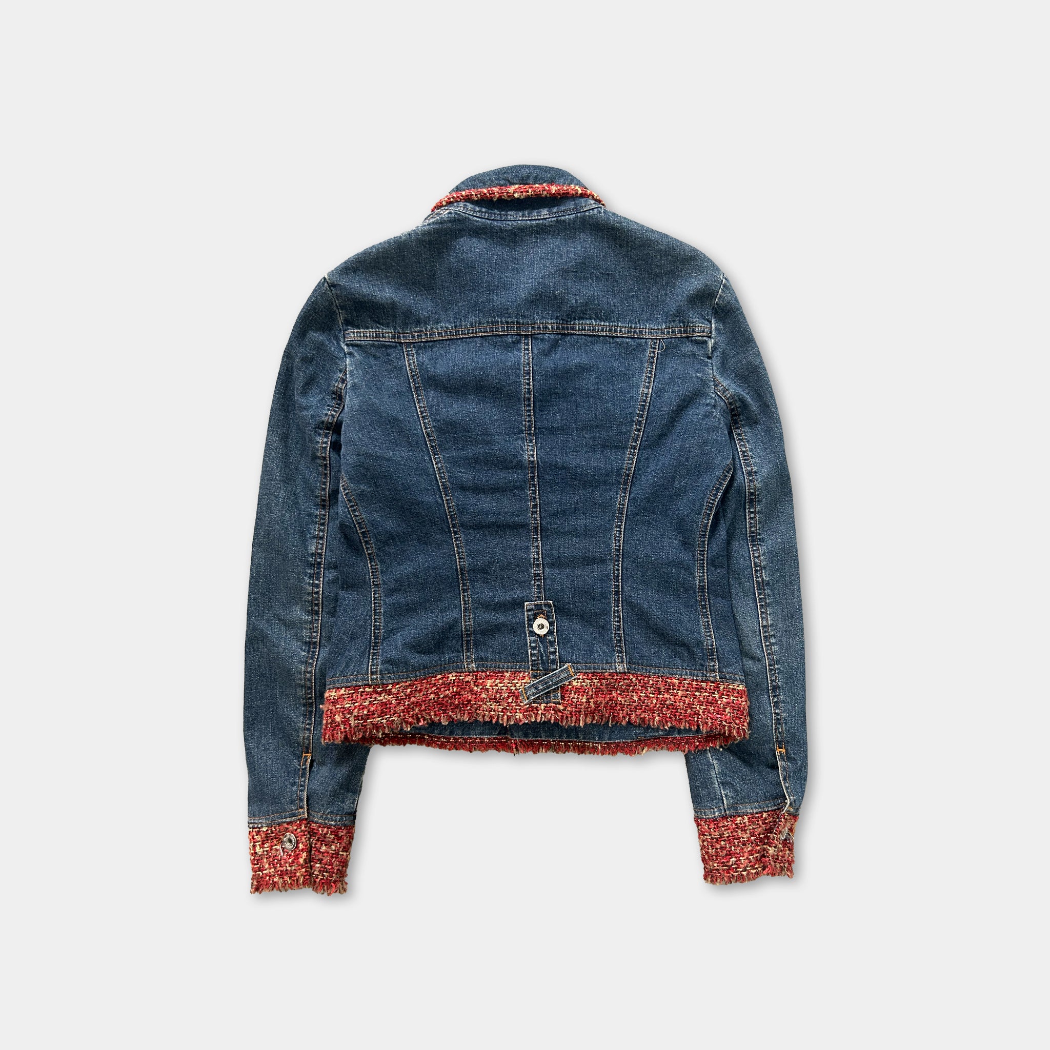 A denim jacket with a red trim, displayed against a white background.